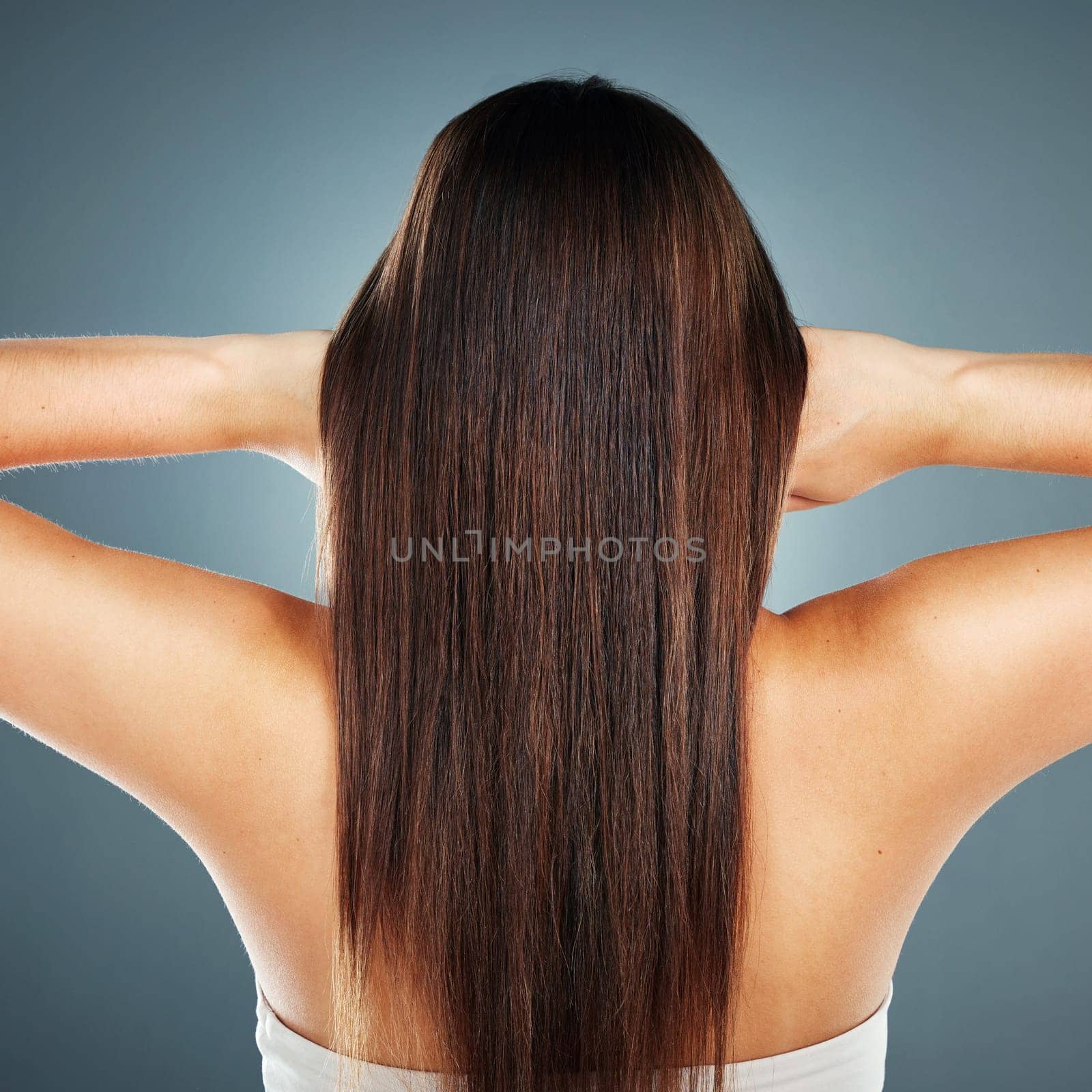 Beauty, salon and wellness model with straight hair texture from smooth, healthy and brazilian keratin shampoo. Cosmetic, shine and beautiful hair care woman in gray studio with back view