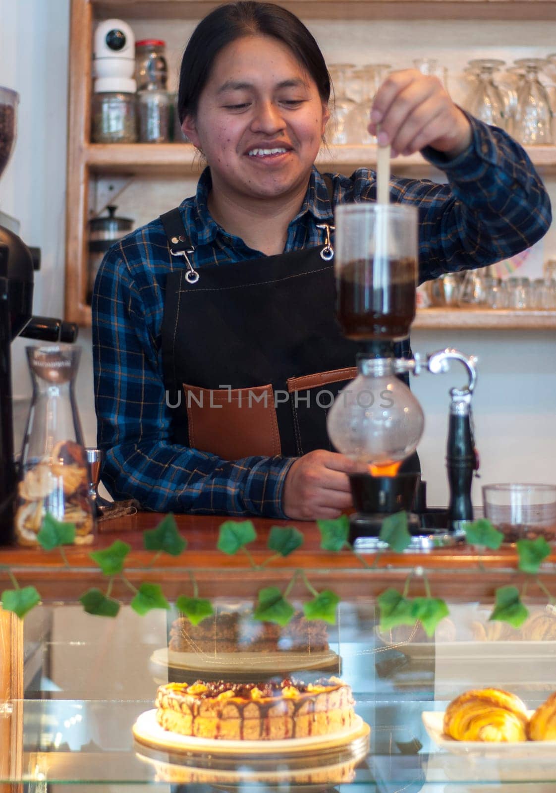 young guy making a coffee in japanese coffee pot very happy. High quality photo
