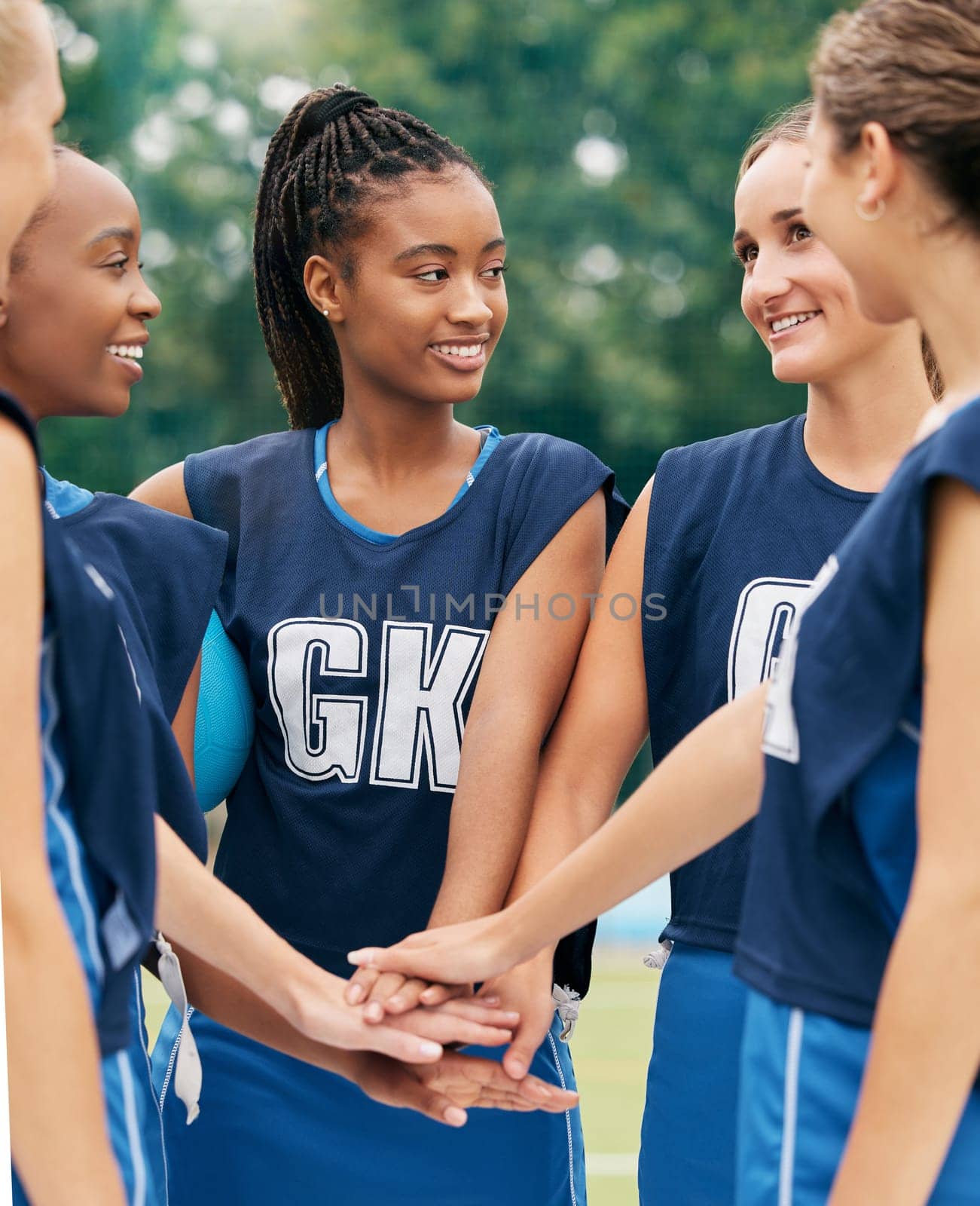 Support, teamwork and sports with netball women for motivation, planning and training on field. Happy, vision and goals with diversity of friends hands in outdoor park for games, summer and workout by YuriArcurs