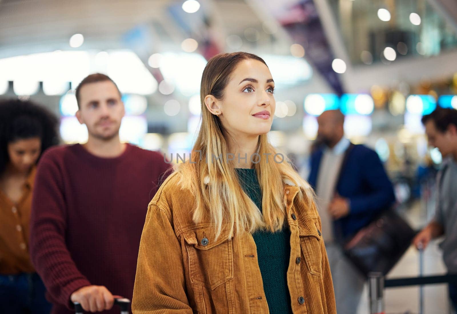 Travel, queue and wait with woman in airport for vacation, international trip and tourism. Holiday, luggage and customs with passenger in line for airline ticket, departure and flight transportation.