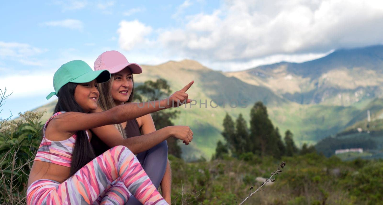 copyspace of mom and daughter in a healthy lifestyle happy and carefree together pointing to a place by Raulmartin