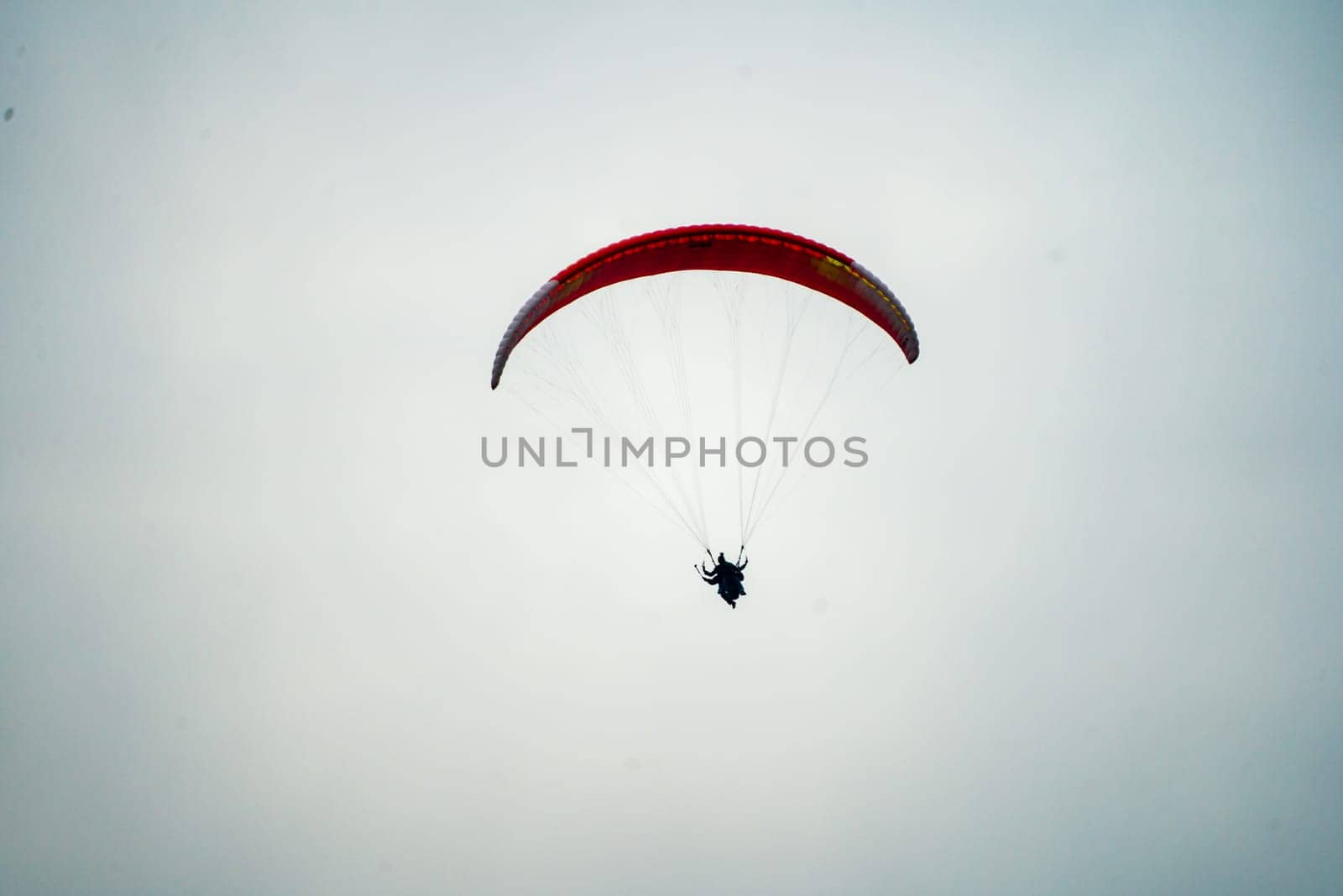 para sailing in manali in fog showing the popular adventure sport in hill stations like manali, kullu, shimla, bir, billing in India