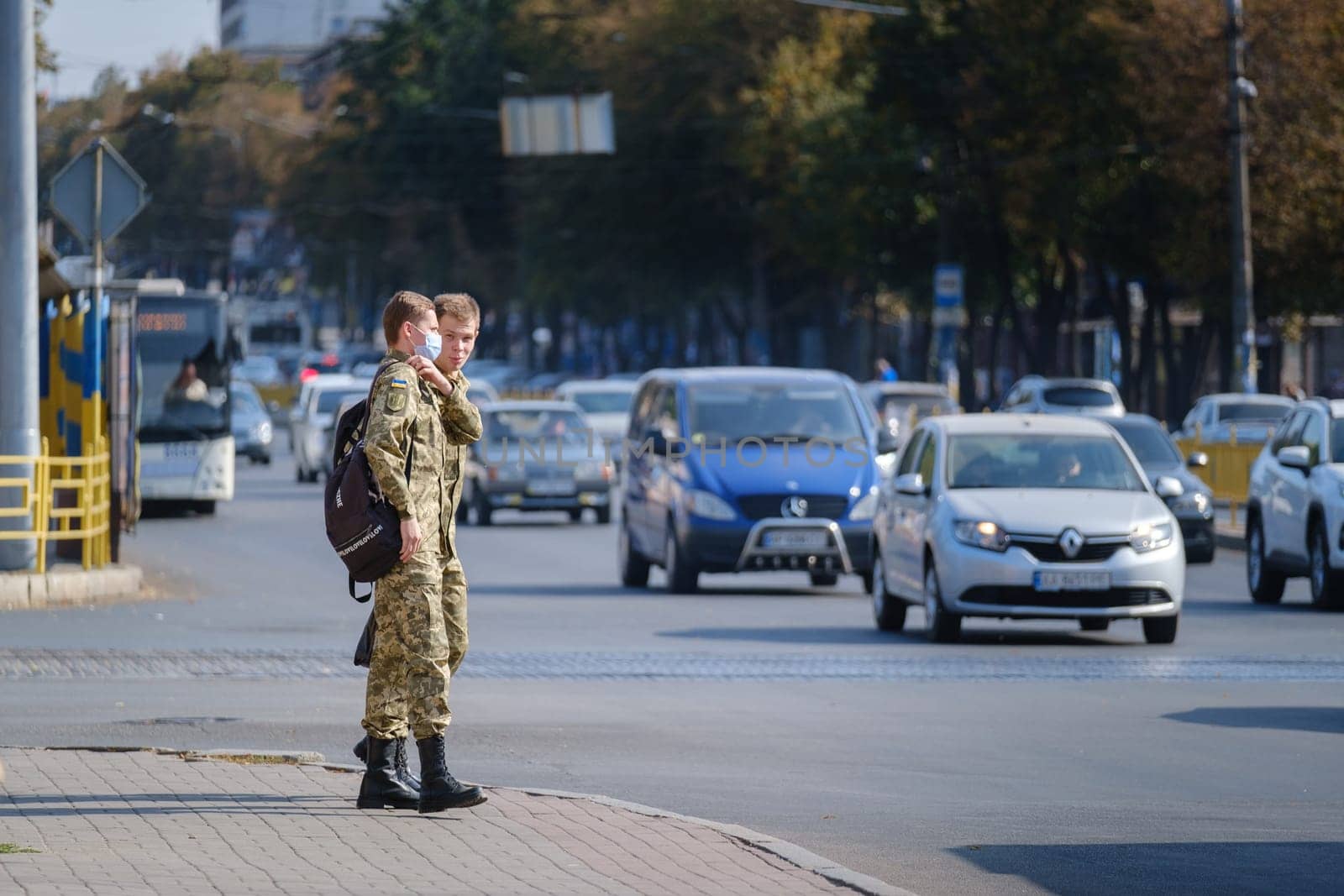 Ukrainian soldiers in national uniform on the city street. national army