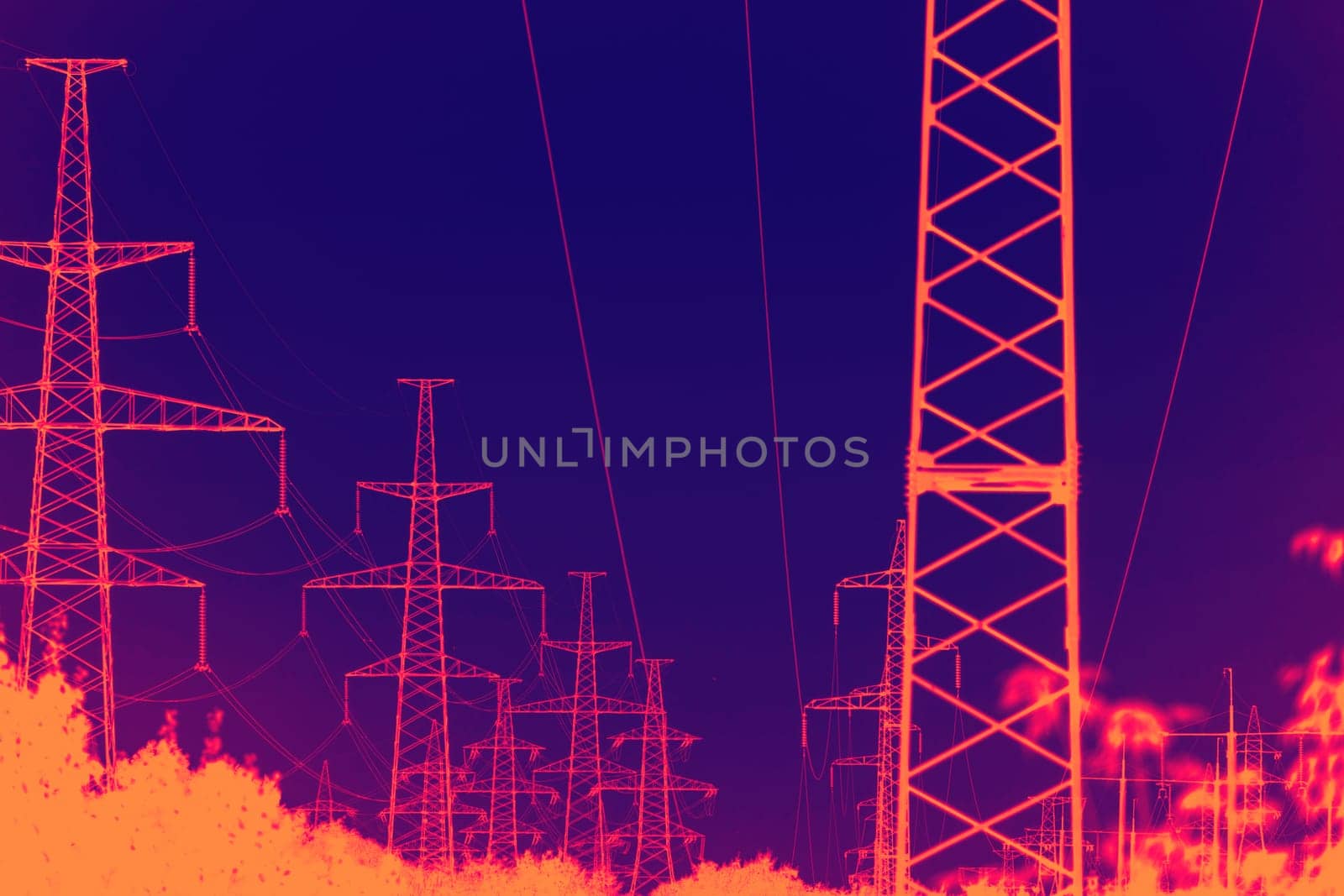 infrared view of high voltage tower. industrial view of high voltage lines.