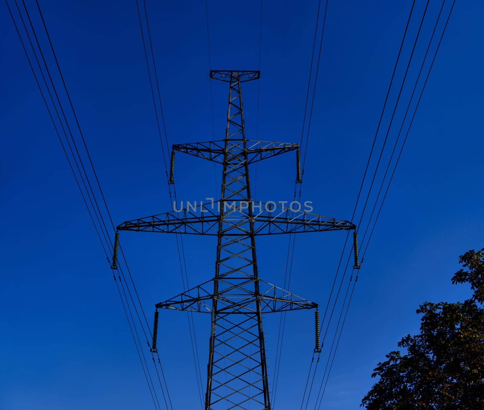 Big High voltage tower with power line cables