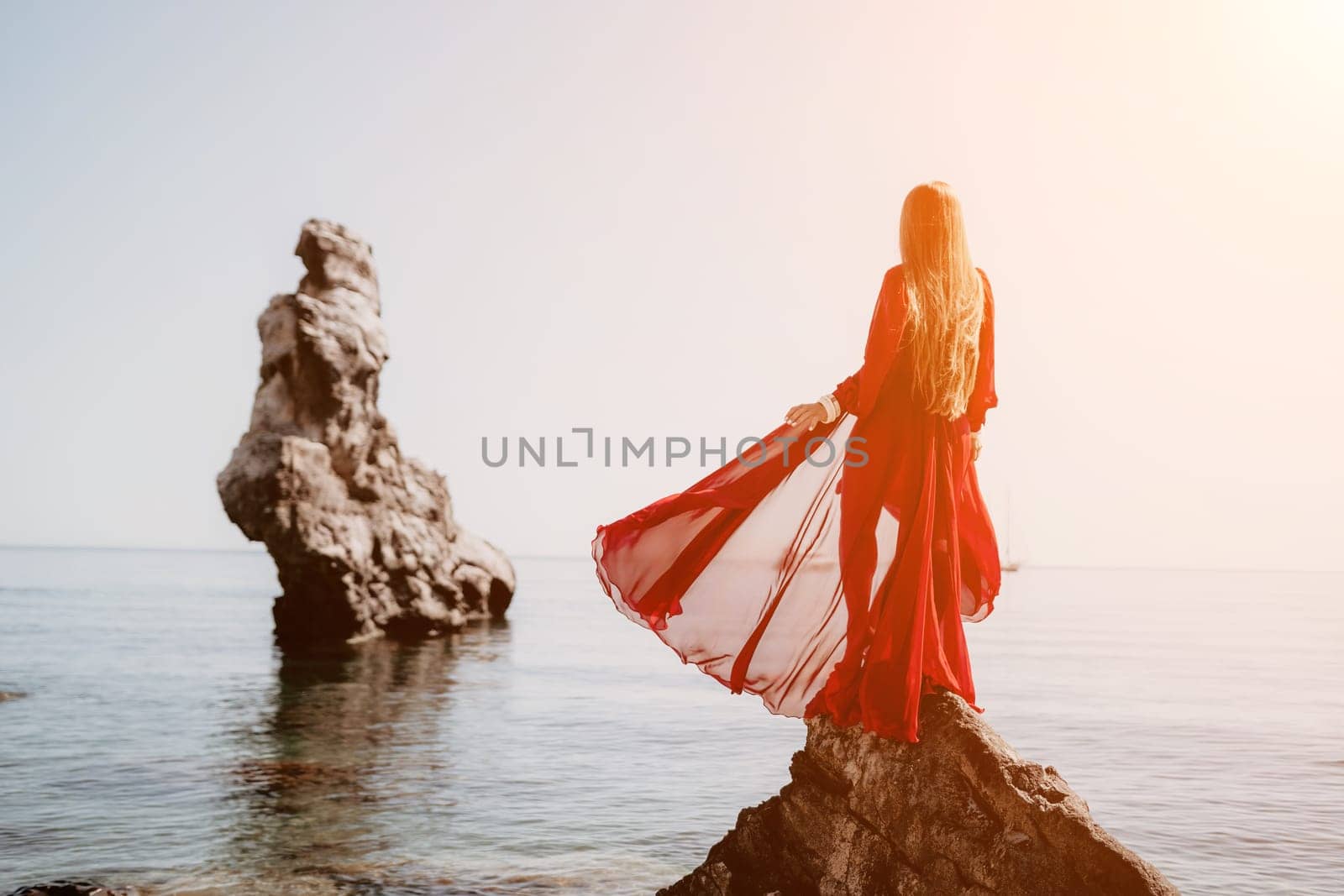 Woman travel sea. Happy tourist taking picture outdoors for memories. Woman traveler looks at the edge of the cliff on the sea bay of mountains, sharing travel adventure journey.