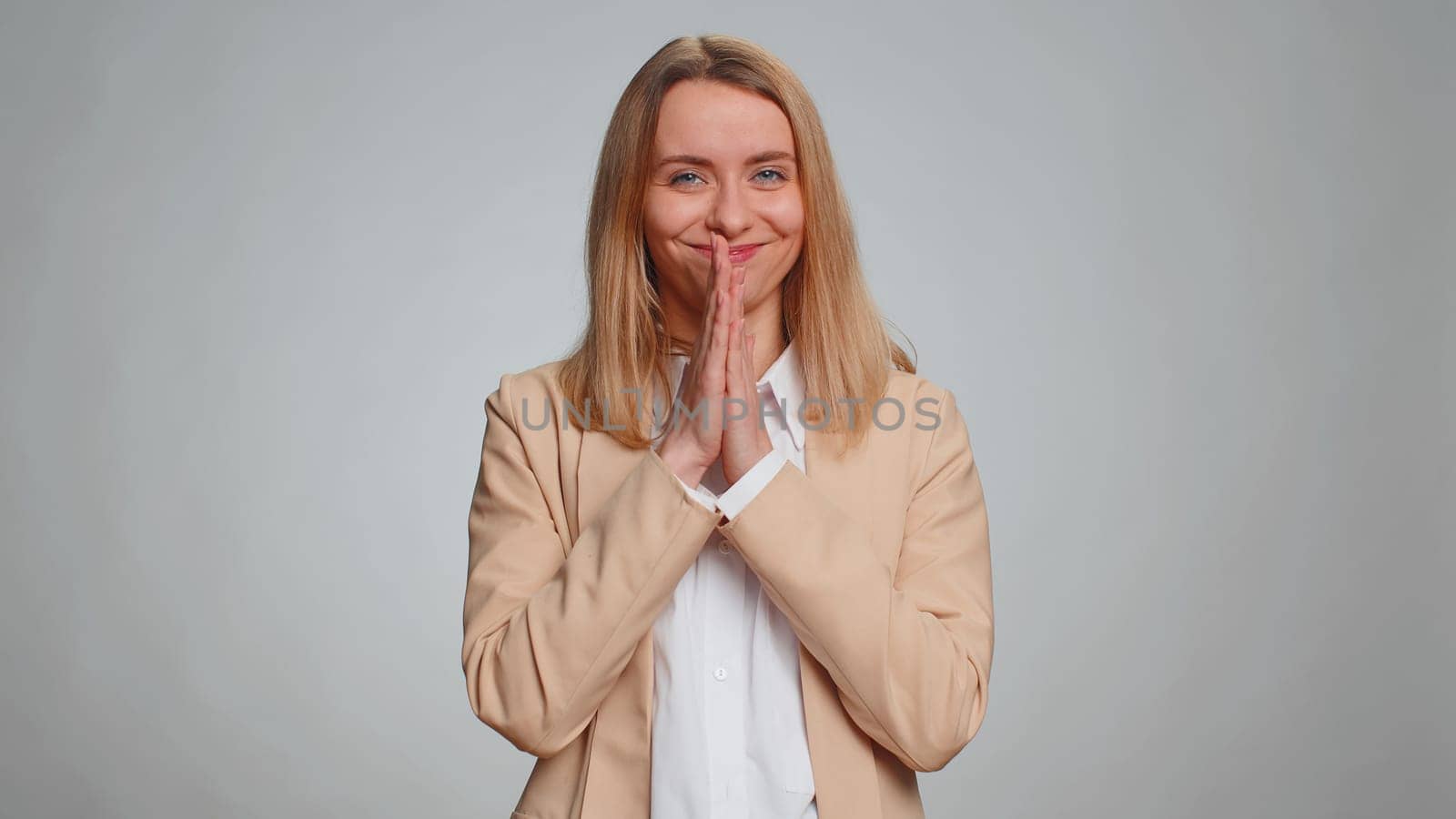 Villain idea. Sneaky businesswoman conspiring scheming, thinking over tricky plan with cunning expression, pondering revenge or evil joke prank. Female girl in suit isolated on gray studio background