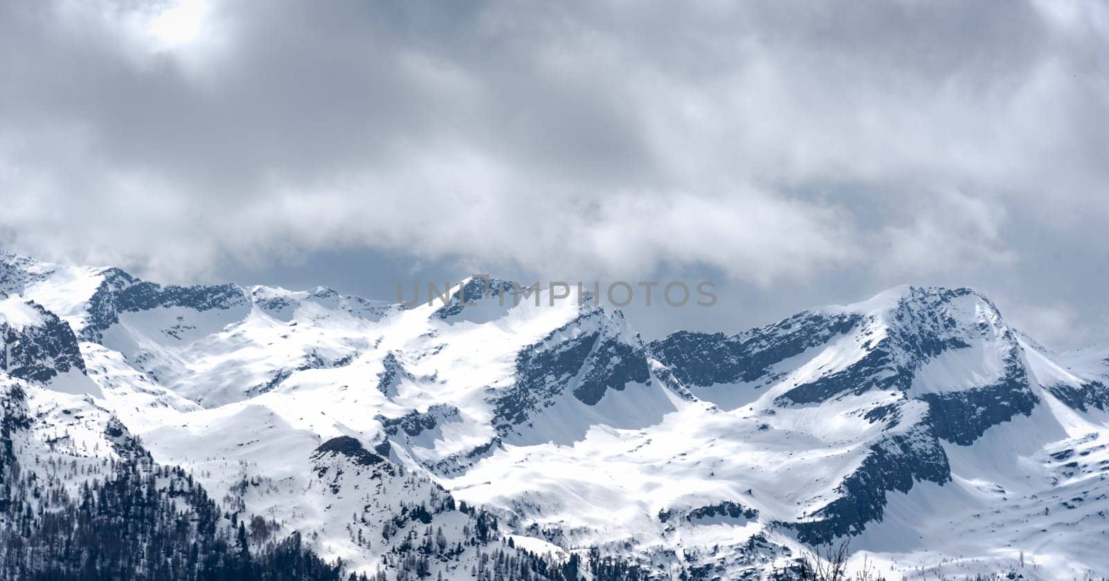 Snowy mountain and cloudy sky in Austrian alps by Millenn