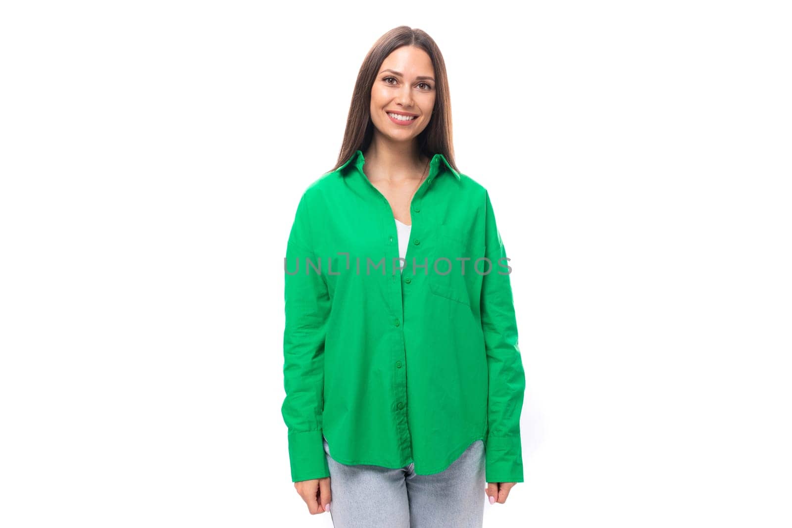 attractive young caucasian brunette lady with makeup dressed in an elegant green shirt on a white background with copy space.