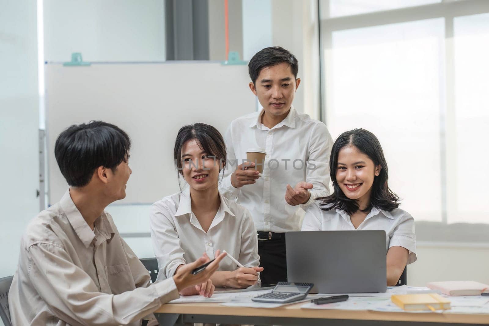 Group of creative asian business meeting and discussing strategy startup project analysis finance .Success asian business people work plan and brainstorm marketing idea with laptop in office.Teamwork..