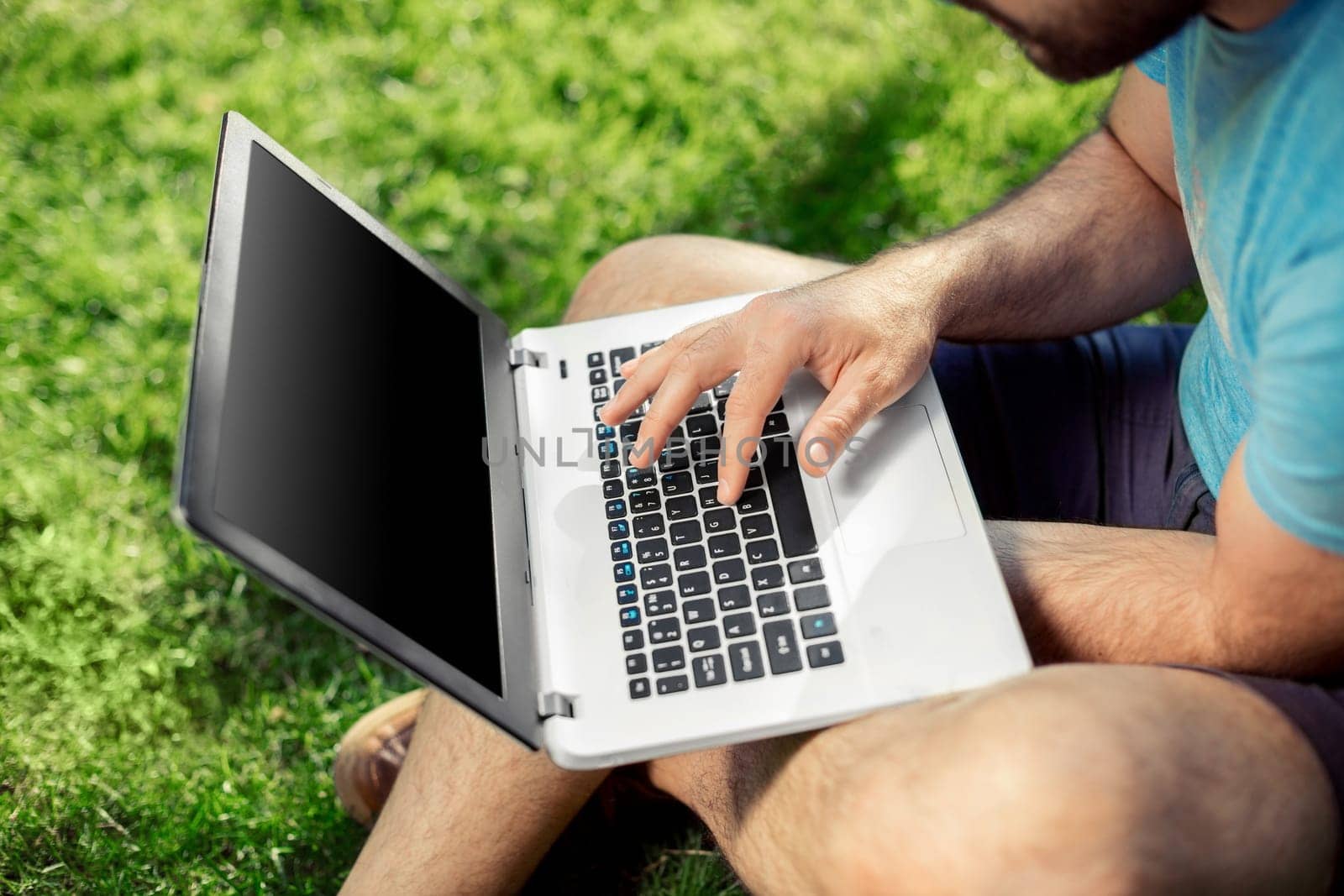 Top view male hands using notebook outdoors in urban setting while typing on keyboard, businessman freelancer working on computer while sitting on city park bench, tourist working on laptop, filter