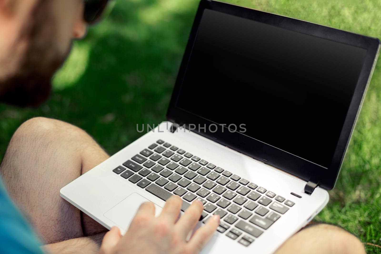 Top view male hands using notebook outdoors in urban setting while typing on keyboard, businessman freelancer working on computer. by nazarovsergey