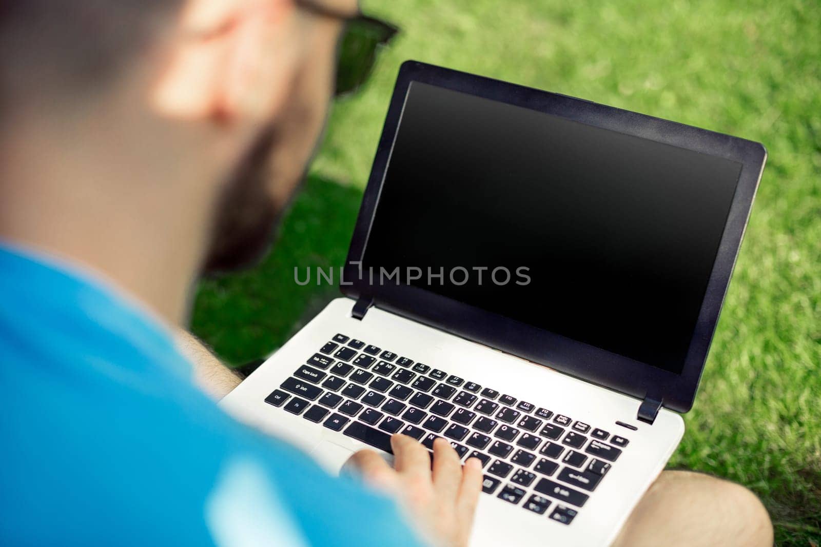 Top view male hands using notebook outdoors in urban setting while typing on keyboard, businessman freelancer working on computer while sitting on city park bench, tourist working on laptop, filter