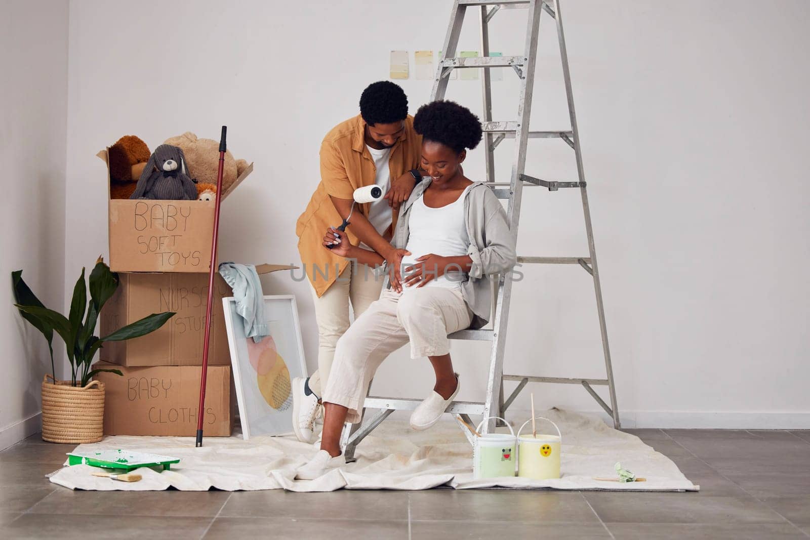 Painting, pregnancy or home with a black couple in DIY, renovation or house remodel with a paintbrush or roller. Teamwork, partners or African man and pregnant woman excited about baby or new family.