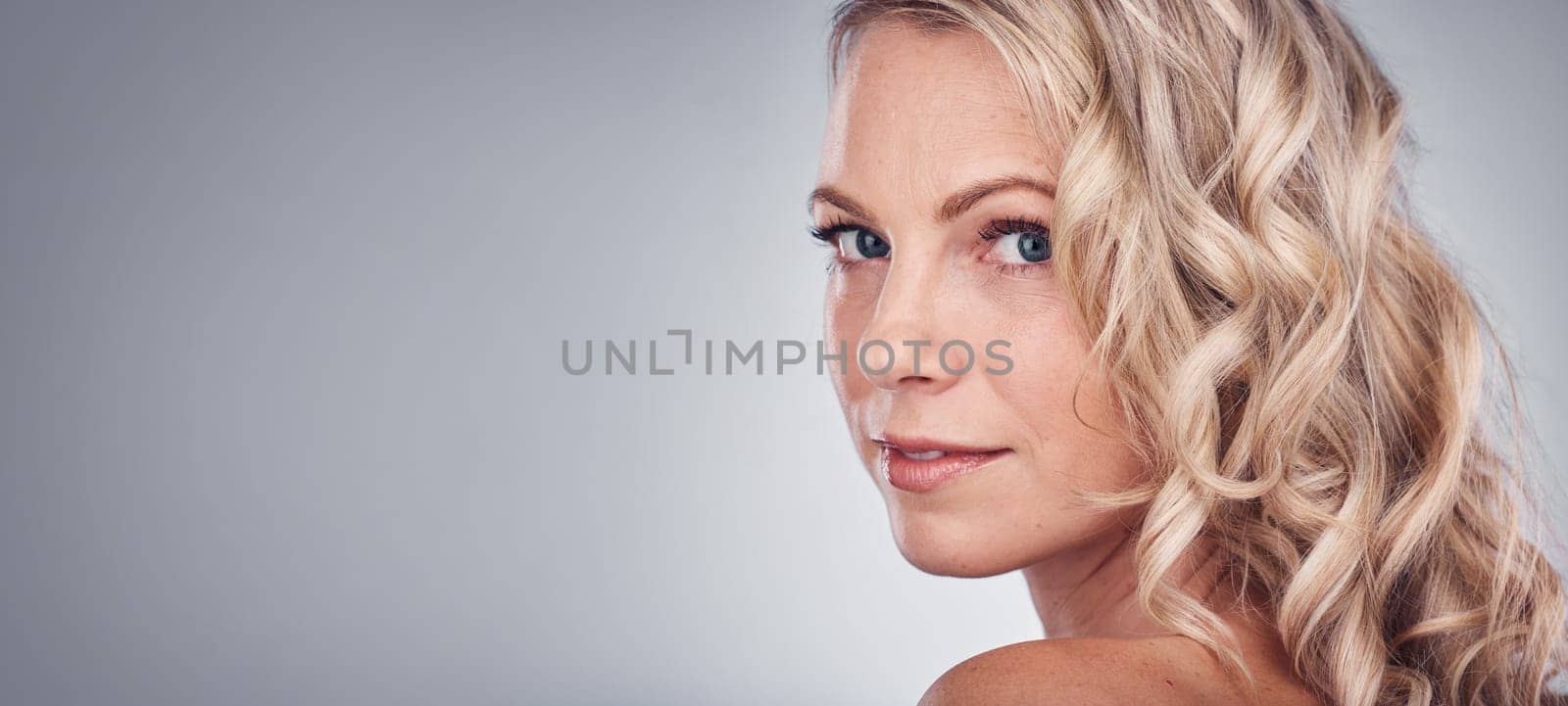 Woman, beauty and portrait smile on mockup for skincare, cosmetics or makeup against a gray studio background. Happy attractive blond female face smiling in satisfaction for facial spa treatment by YuriArcurs