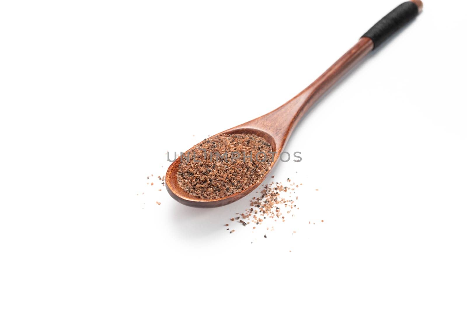 isolated himalayan black salt, Kala Namak on wooden sppon, cooling spice ayurvedic Indian Asian cuisine, healthy food. Kiln-fired rock salt with a sulphurous pungent smell.White background.Horizontal