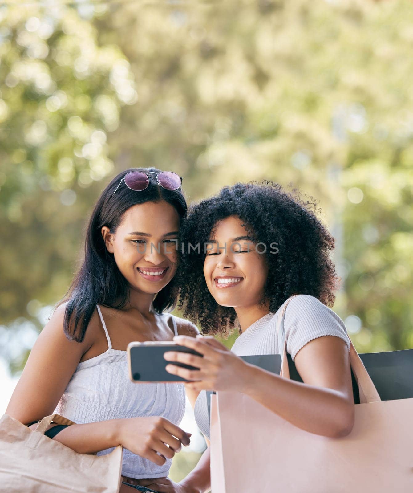 Friends, phone and selfie for retail shopping bonding moment together with smile for purchase choices. Black people, shopper and smartphone photograph of happy gen z women for social media