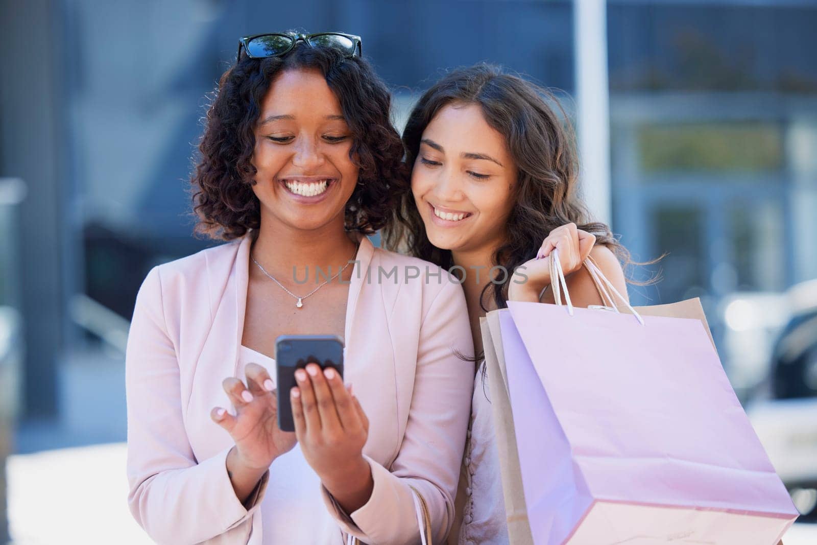 Black woman, phone and online shopping with friends, city and bag with smile, meme and excited. Women, smartphone and texting in metro on social media app with happiness in summer with e-commerce ux by YuriArcurs