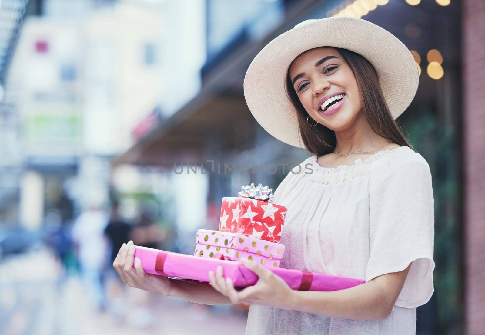 Gifts, boxes and portrait of a woman in a shopping mall buying products for a party, event or celebration. Happy, smile and female purchasing presents for valentines day, anniversary or romance