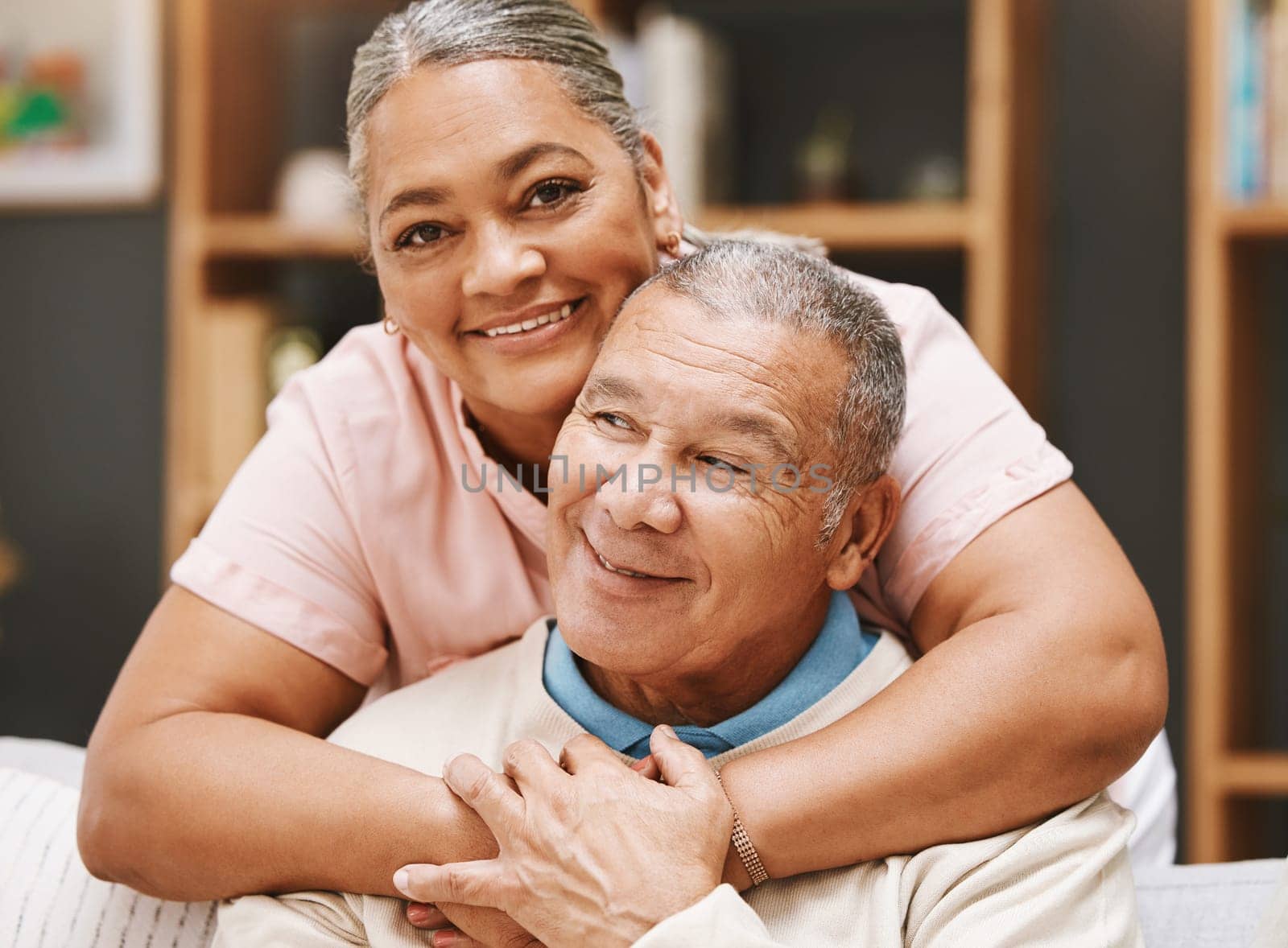 Love, senior couple and hug in living room home, bonding caring and smiling. Valentines day, romance and portrait of man and woman hugging, embrace and cuddle for support while enjoying time together.