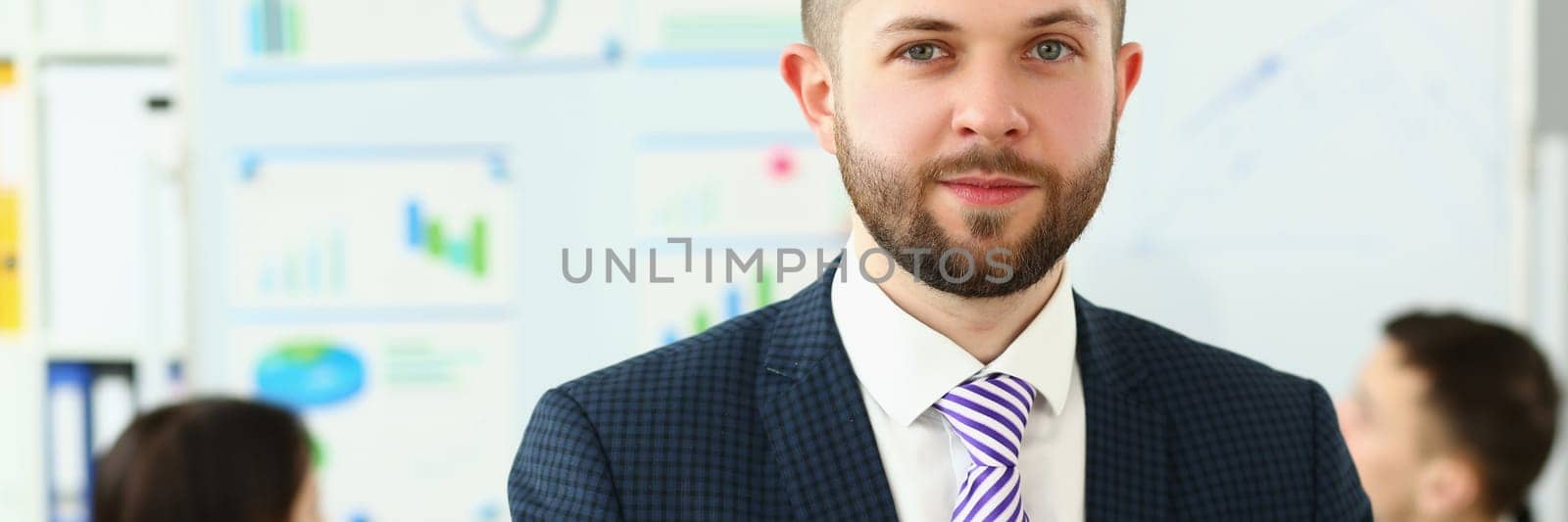 Portrait of a young smiling businessman successful entrepreneur winning meeting by kuprevich