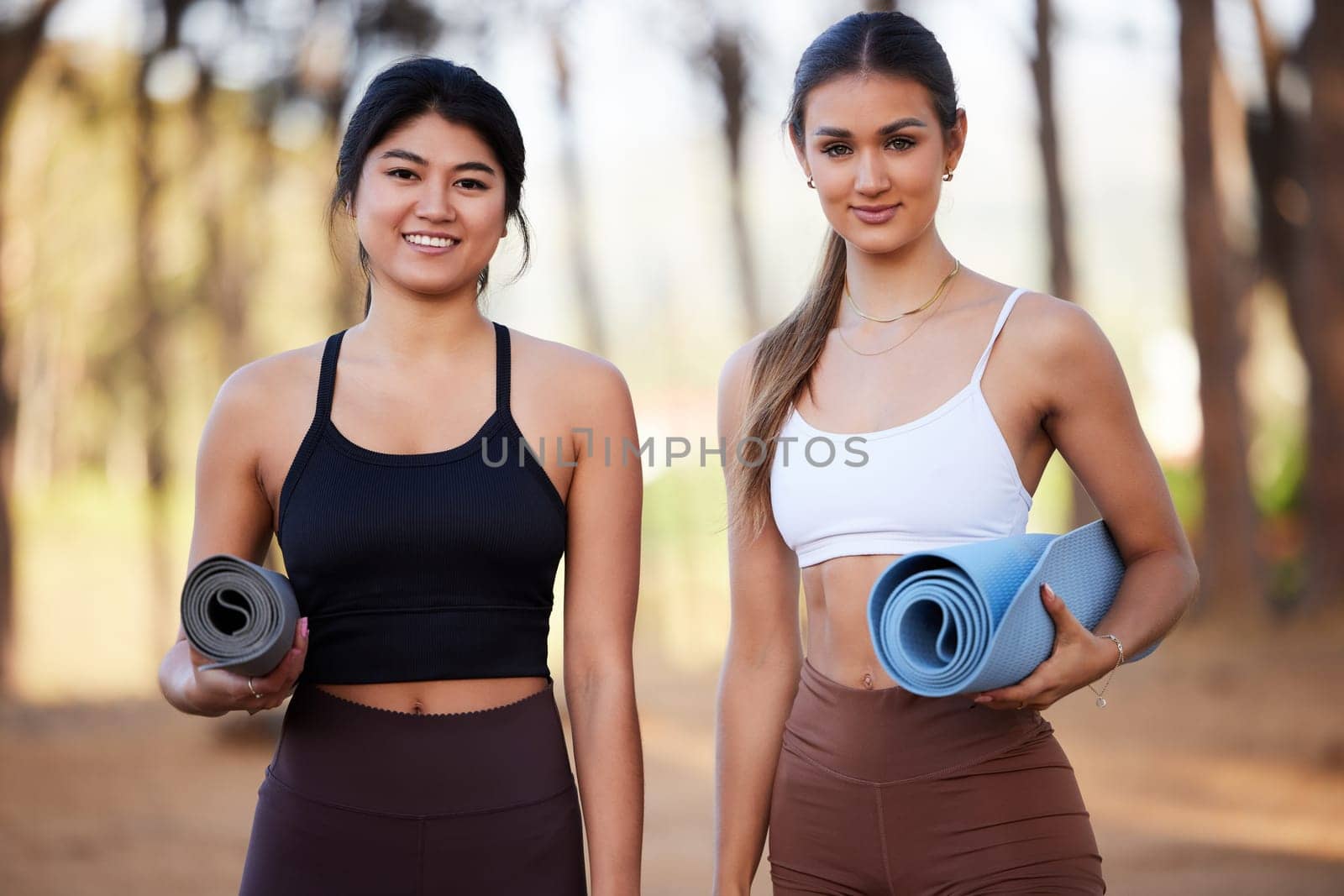 Portrait, yoga and fitness with woman friends in the forest for wellness, mental health or spiritual balance. Health, nature or diversity with a young female yogi and friend outdoor in the woods.