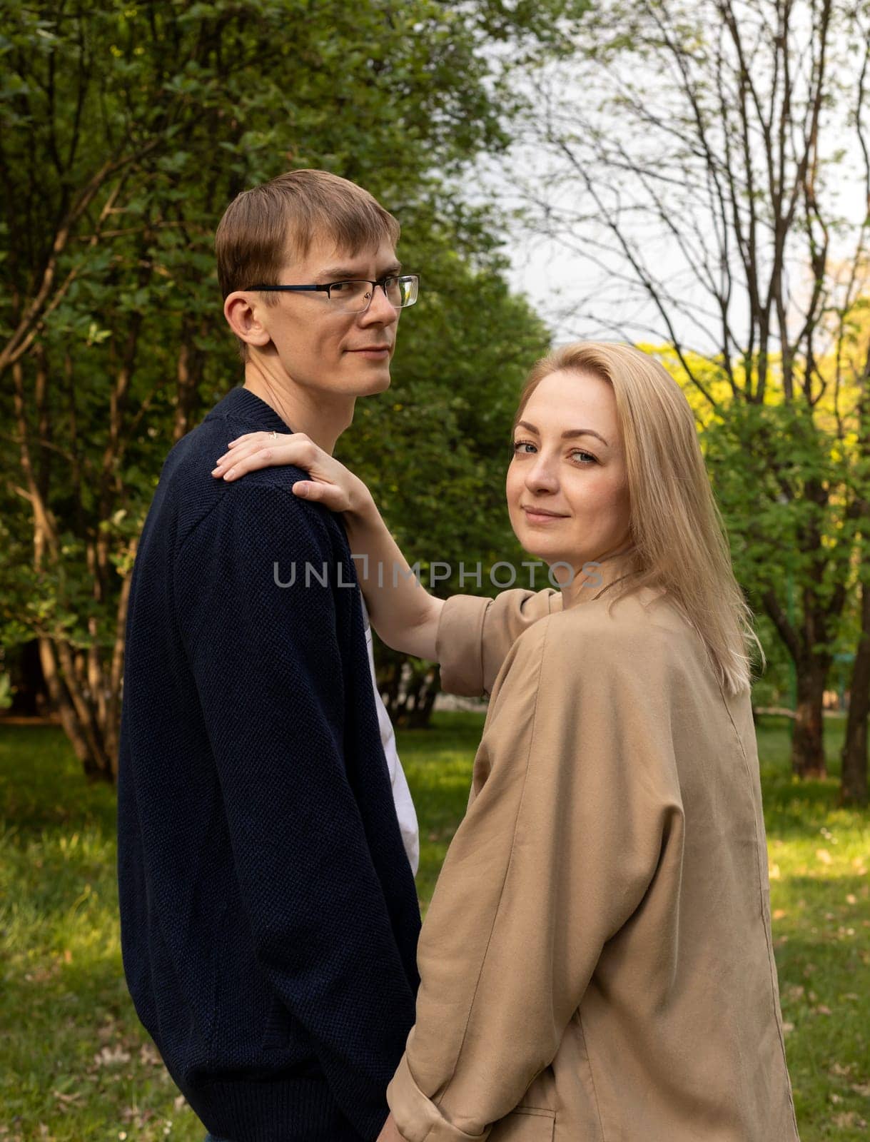 Couple In Park. White Woman Holding Hand On Man's Shoulder. Relationship, Togetherness. Enjoying Time Together. Feelings. Vertical Plane Summer Time by netatsi