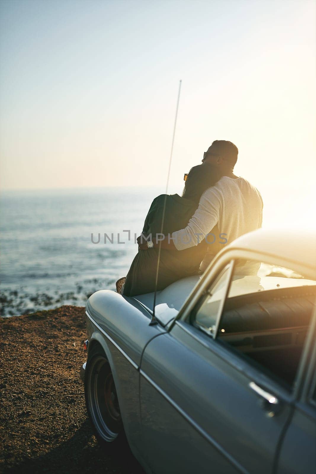 Go and see the beauty in the world. a young couple making a stop at the beach while out on a road trip. by YuriArcurs