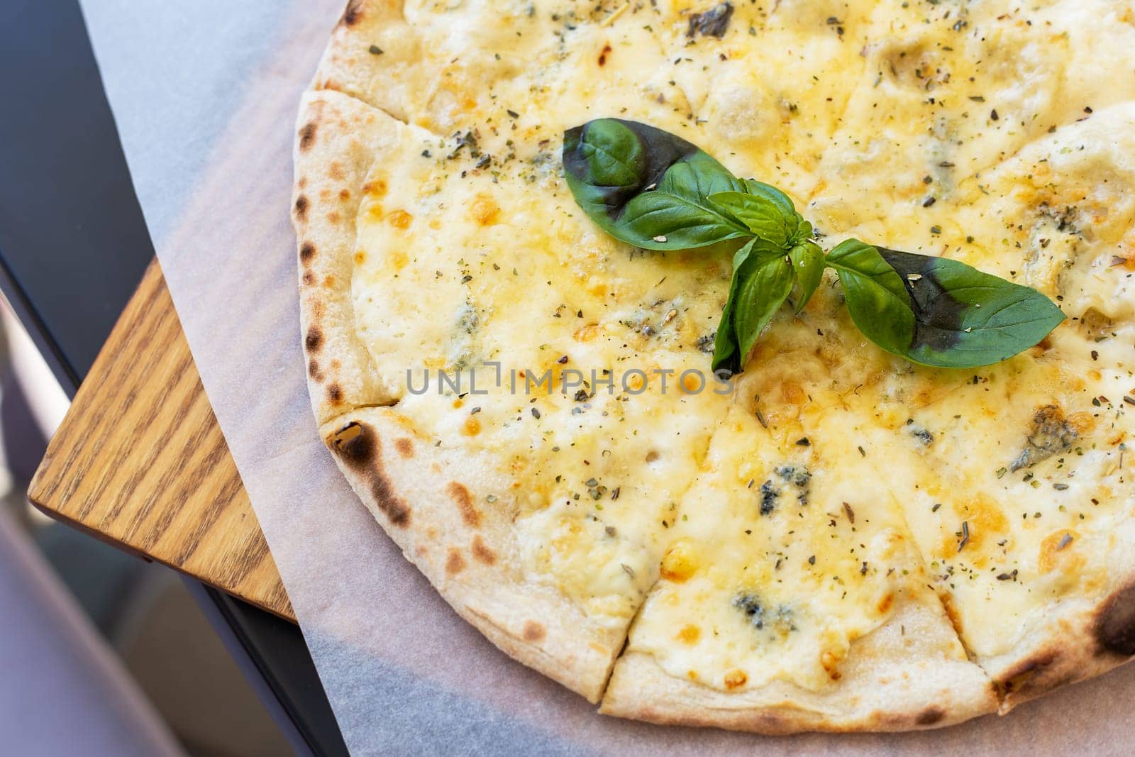 Fragrant Italian pizza of four cheeses - parmesan, dor blue, mozzarella, cheddar, Close up, top view