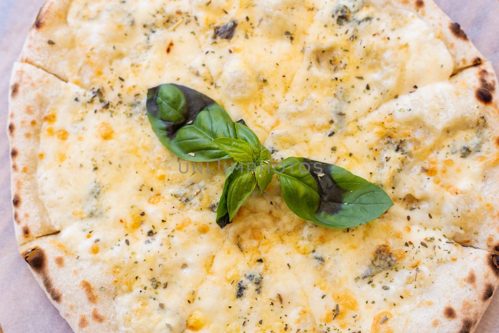 Fragrant Italian pizza of four cheeses - parmesan, dor blue, mozzarella, cheddar, Close up, top view