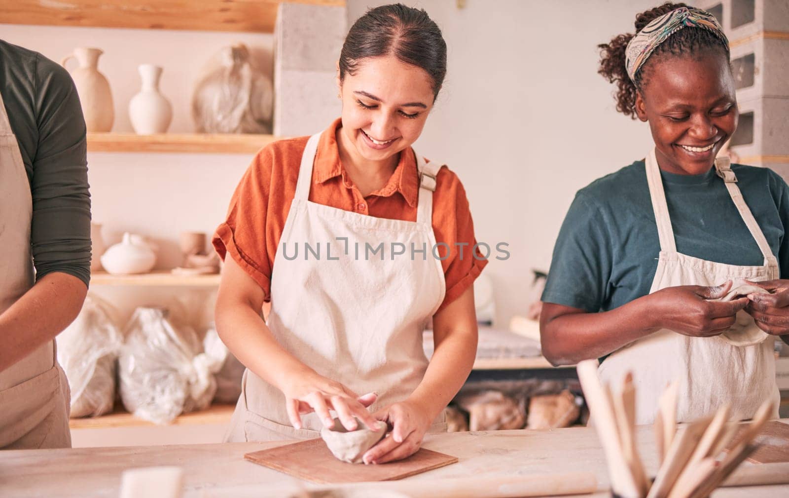 Pottery class, group workshop or happy people design sculpture mold, clay manufacturing or art product. Diversity, ceramic retail store or startup small business owner, artist or studio women molding by YuriArcurs