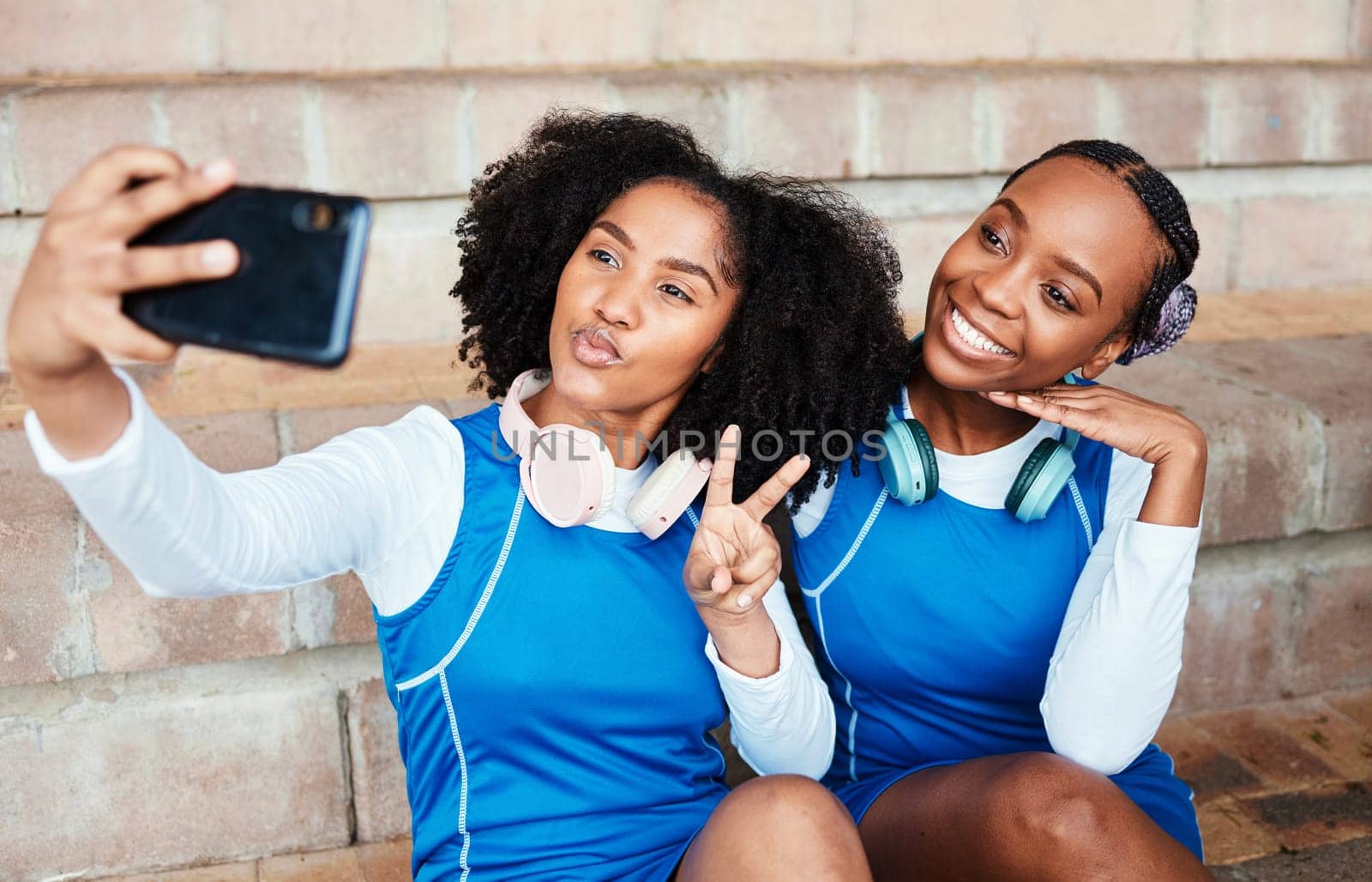 Sports, friends and selfie by netball team on steps with smile, hand and peace sign, happy and relax. Social media, girl and sport influencer pose for photo, profile picture or blog update outdoor by YuriArcurs