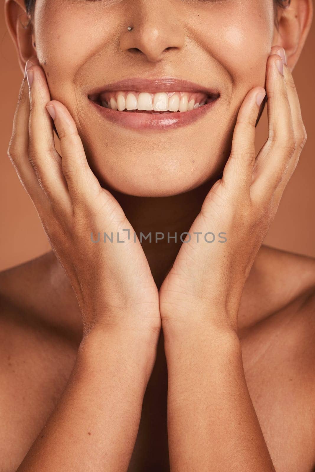 Dental, oral care and closeup of woman teeth with whitening, hygiene and health in a studio. Happy, smile and girl model with a natural, clean and healthy mouth isolated by a brown background. by YuriArcurs