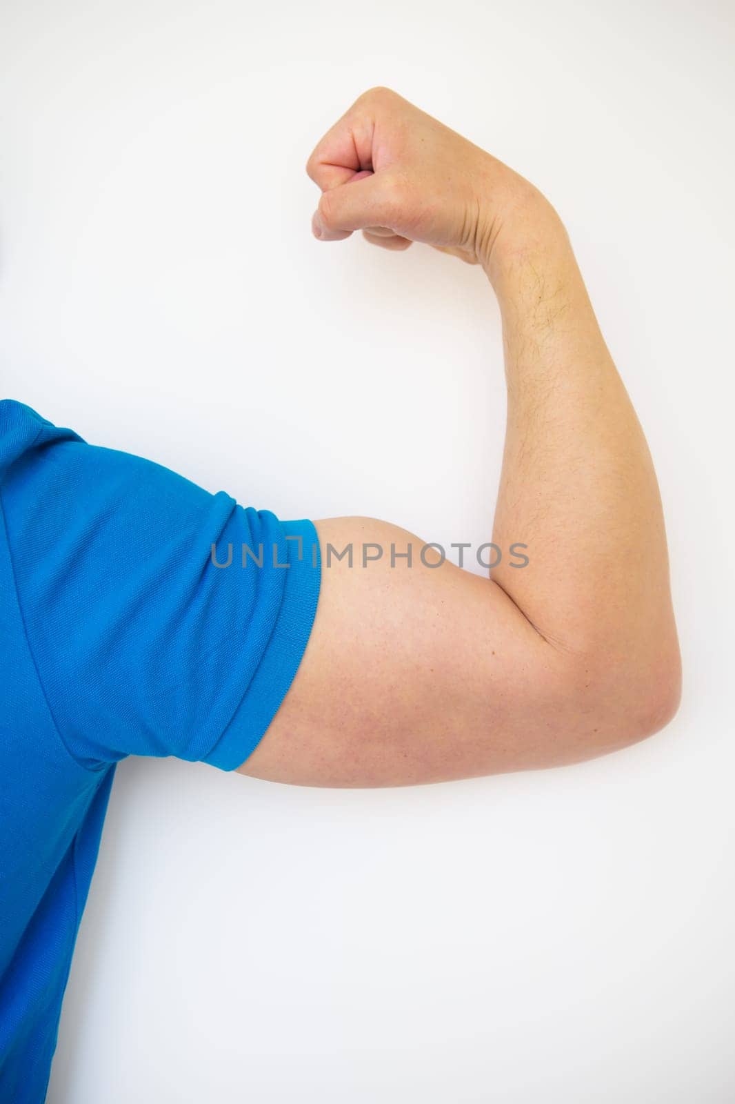 Close up of a handsome male hand showing biceps on a white background. Health and sport concept. Close-up, place for an inscription.