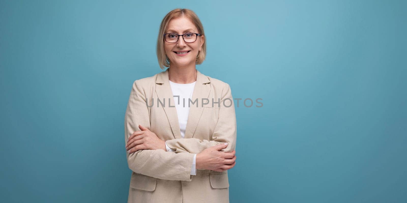 cheerful middle aged business woman on bright studio background with copy space.