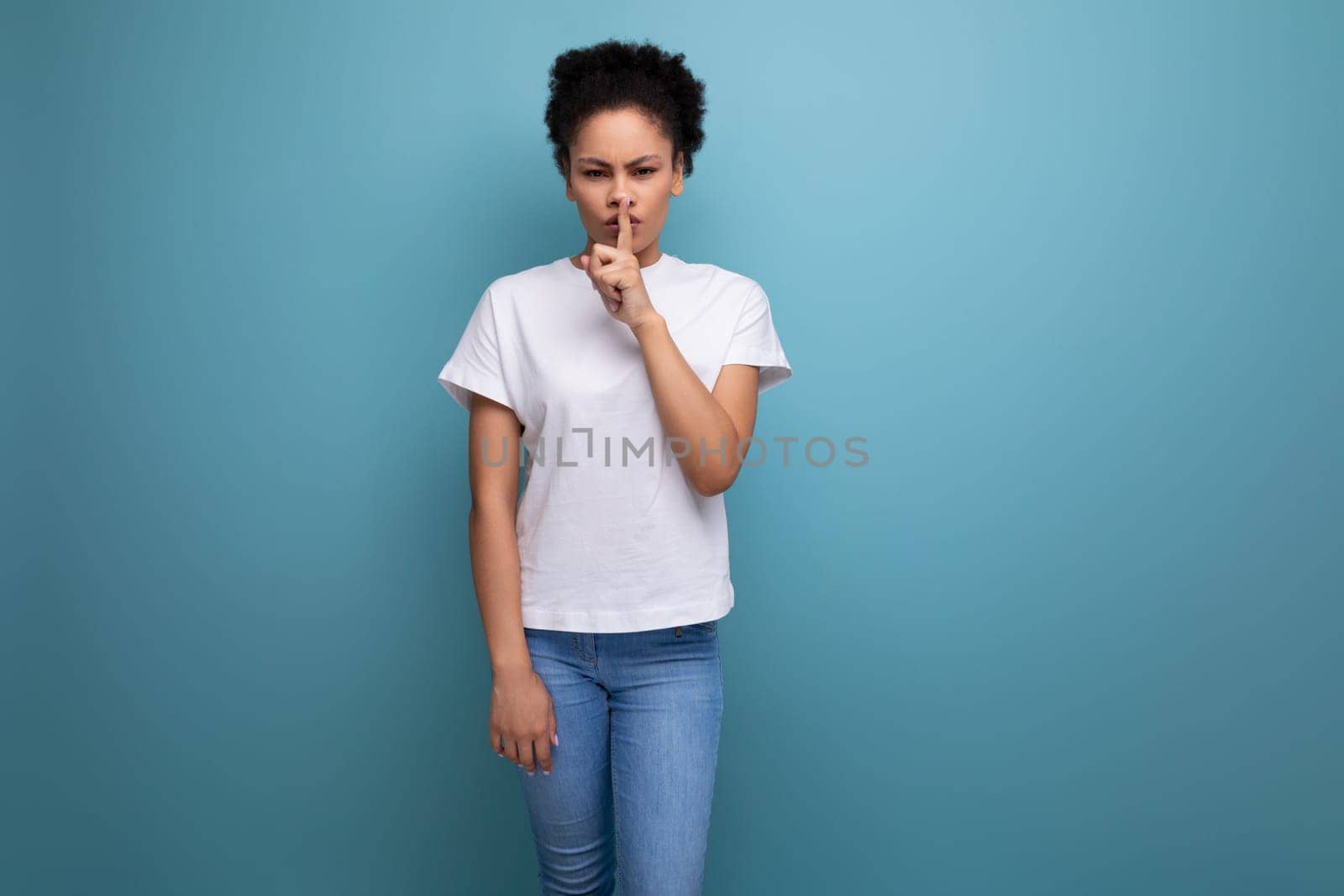 beautiful young swarthy woman with porous curly hair, dressed in a white T-shirt without a pattern by TRMK
