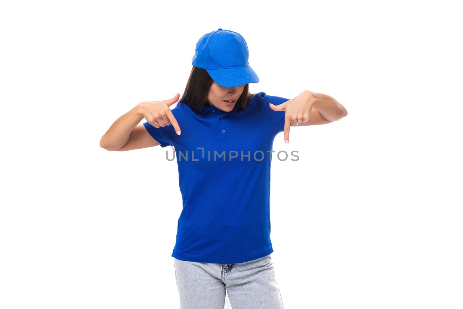 well-groomed pretty young caucasian brunette woman in uniform t-shirt and cap with mockup for print.