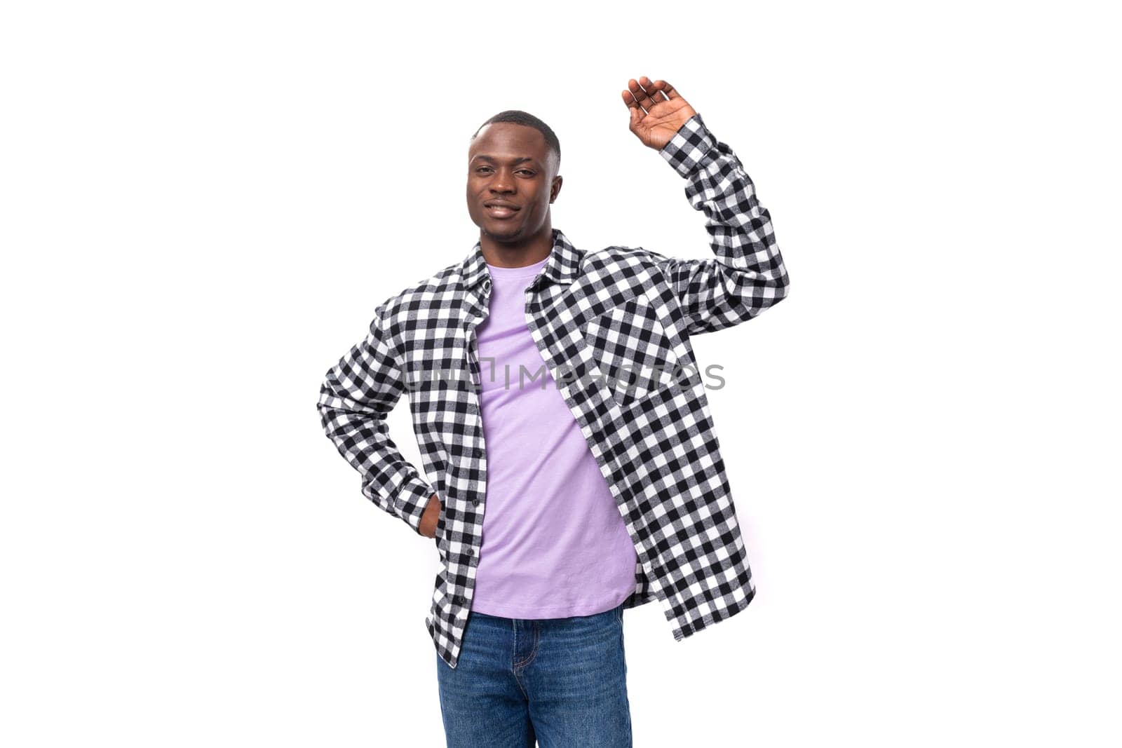 portrait of a handsome 30 year old african guy dressed in a plaid shirt against the background with copy space.