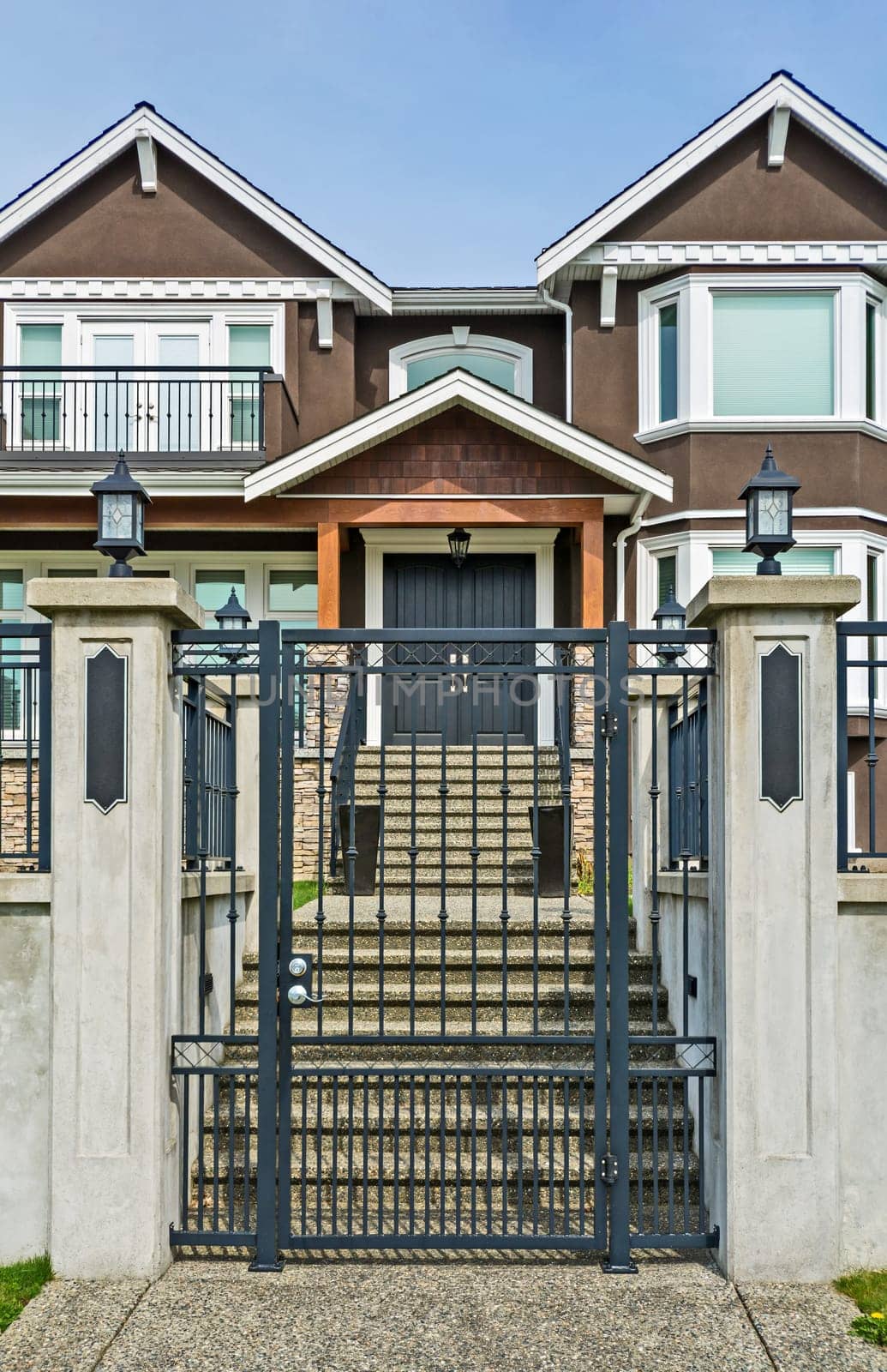Luxury residential houses with metal gate at the front.