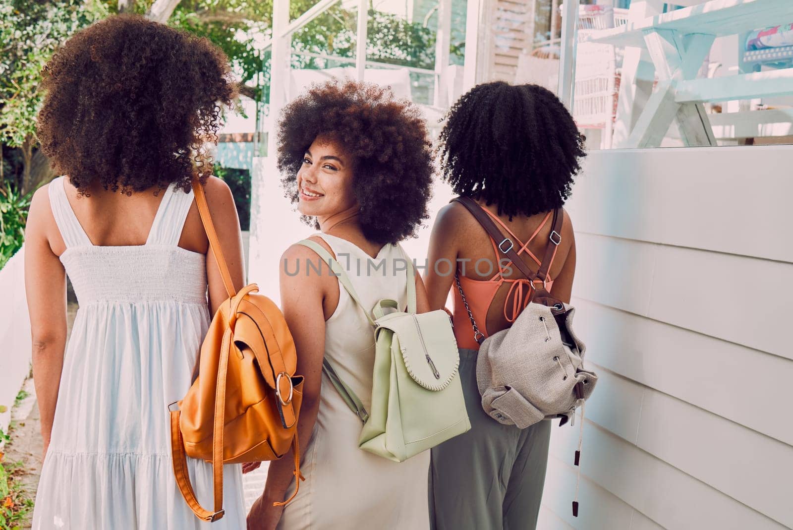 Friends, happy and travel holiday, summer and walking outdoor in Cuba, bag and beauty with afro and tropical weather. Young women, latino and walk on vacation, happiness and enjoy travelling outside.