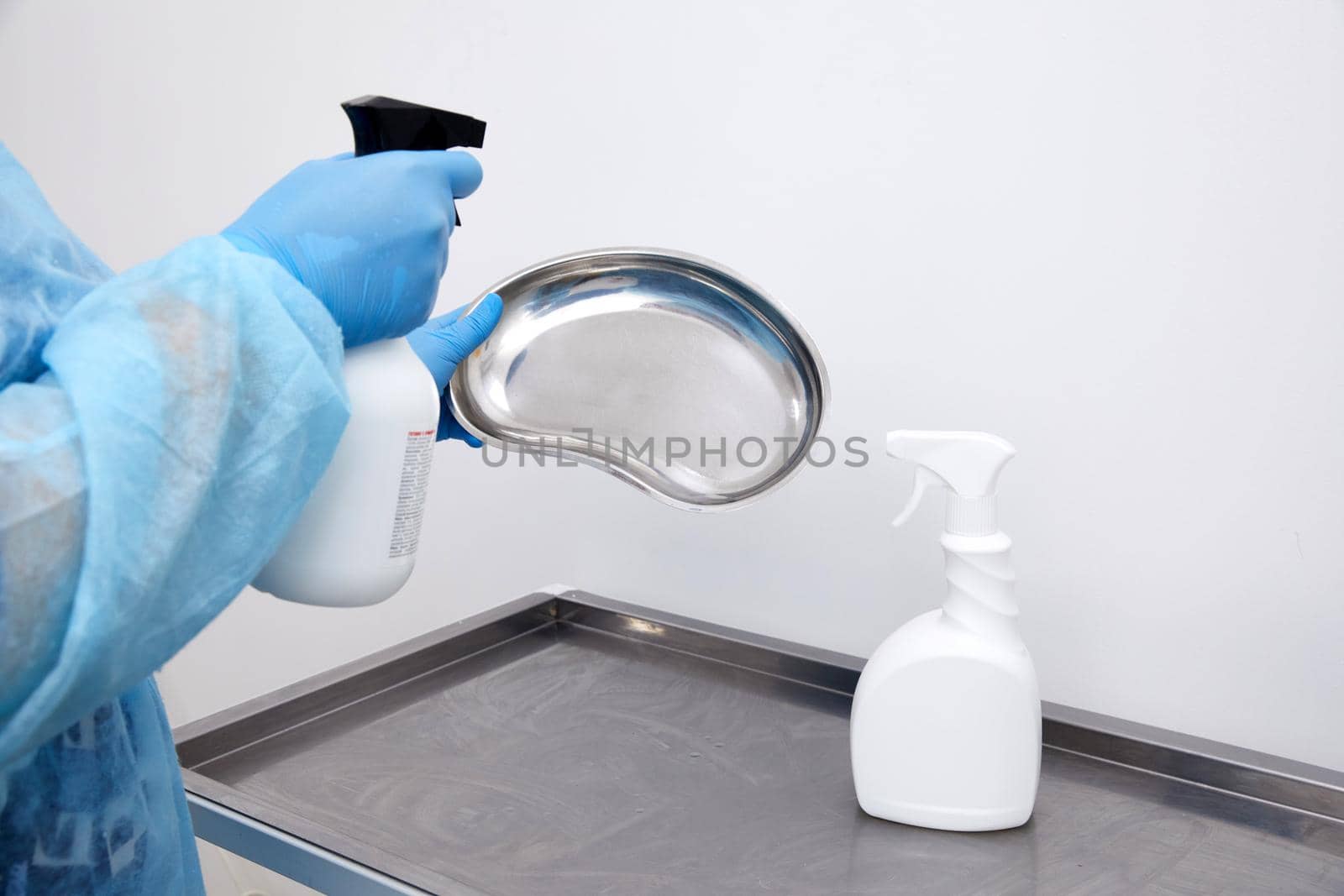Disinfect medical instruments with sprayer in clinic. Disinfection and cleaning concept