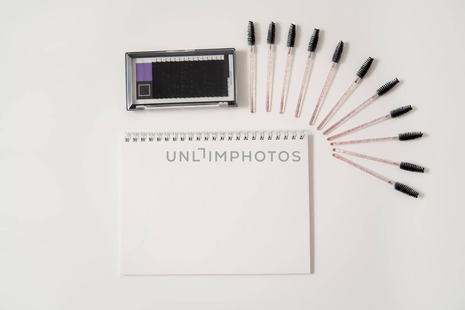 Set of eyelash instruments with a notepad and copyspace