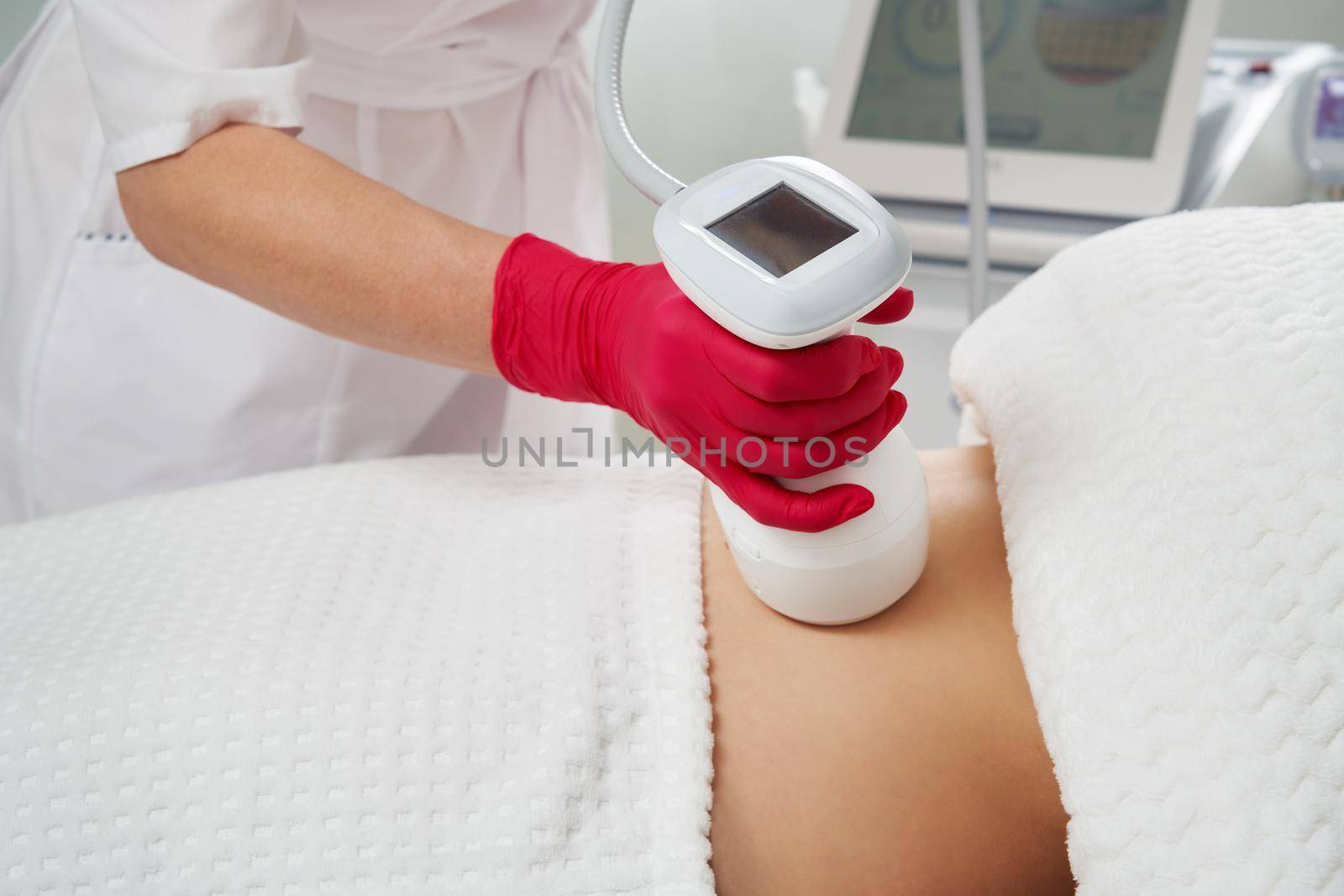Expert Beautician Doing Abdomen Cavitation Treatment with Ultrasonic Massage Therapy to Reduce Fat