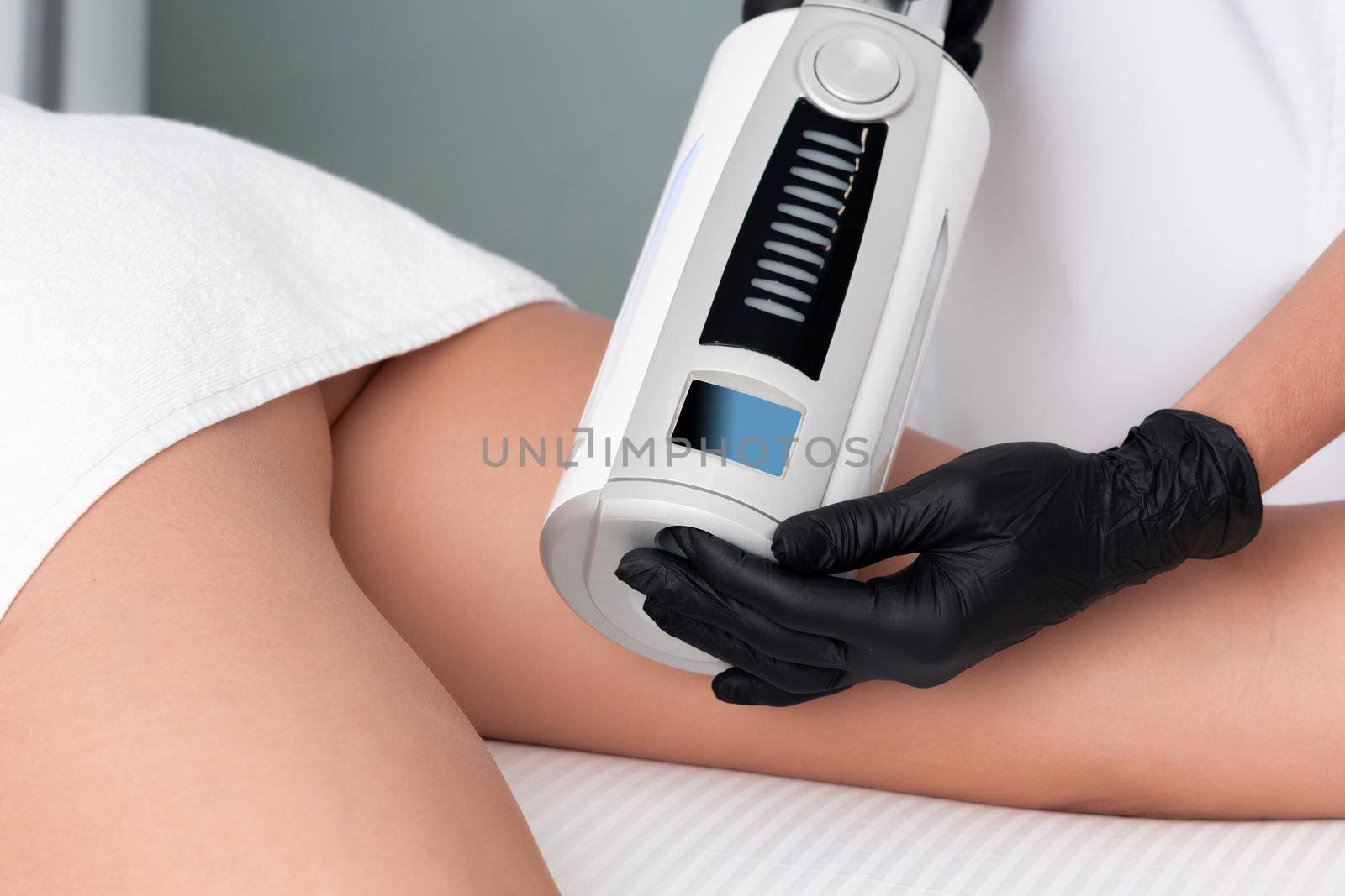 Partial view of cosmetologist in rubber gloves doing endospheres therapy