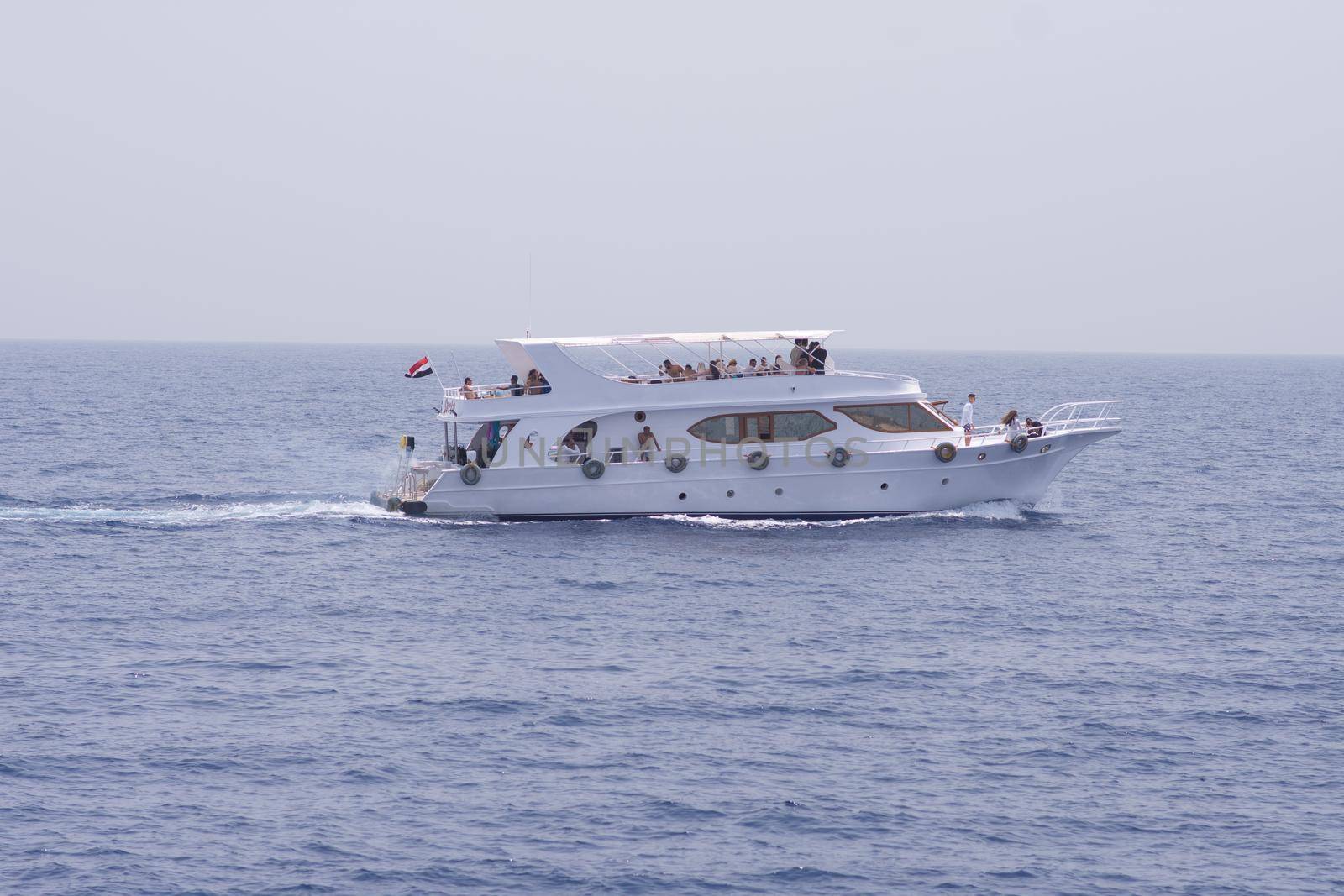 Egypt, Sharm el-Sheikh, Red Sea - August 05. 2021: people on a beautiful white yacht are sailing on the sea. tourist boat trip. side view. Editorial.