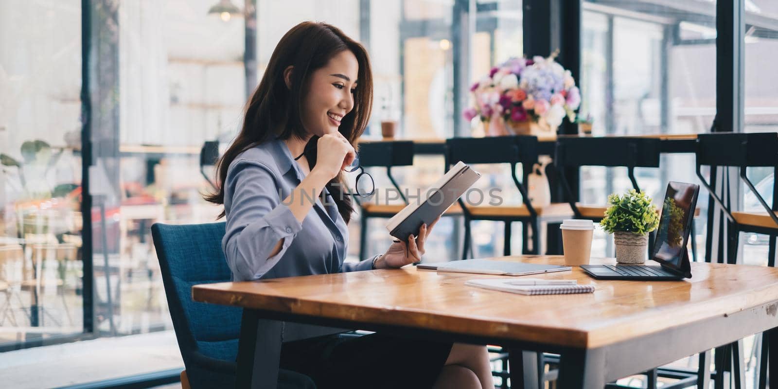 Photo of gorgeous secretary working at office. she sitting at the wooden desk.