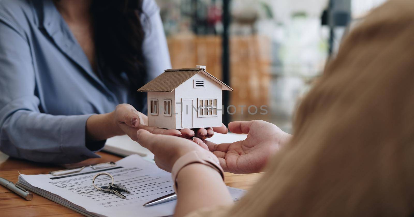 Real estate agent or sales manager offer home sale and explained the terms of signing the house purchase contract and free home insurance. Mortgage property insurance dream moving home concept. by nateemee