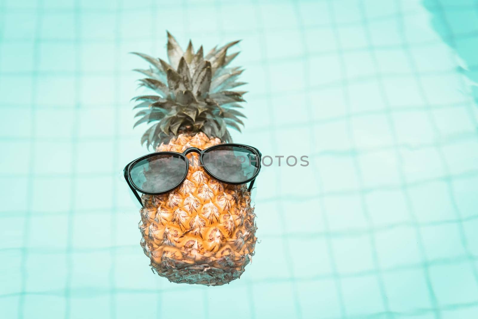 Summer Vacation and Swimming Pool Relaxation Lifestyles Concept, Pineapple With Sunglasses in Poolside at The Beach Vacations. Tropical Leisure Activities Relaxing and Holiday Resort by MahaHeang245789