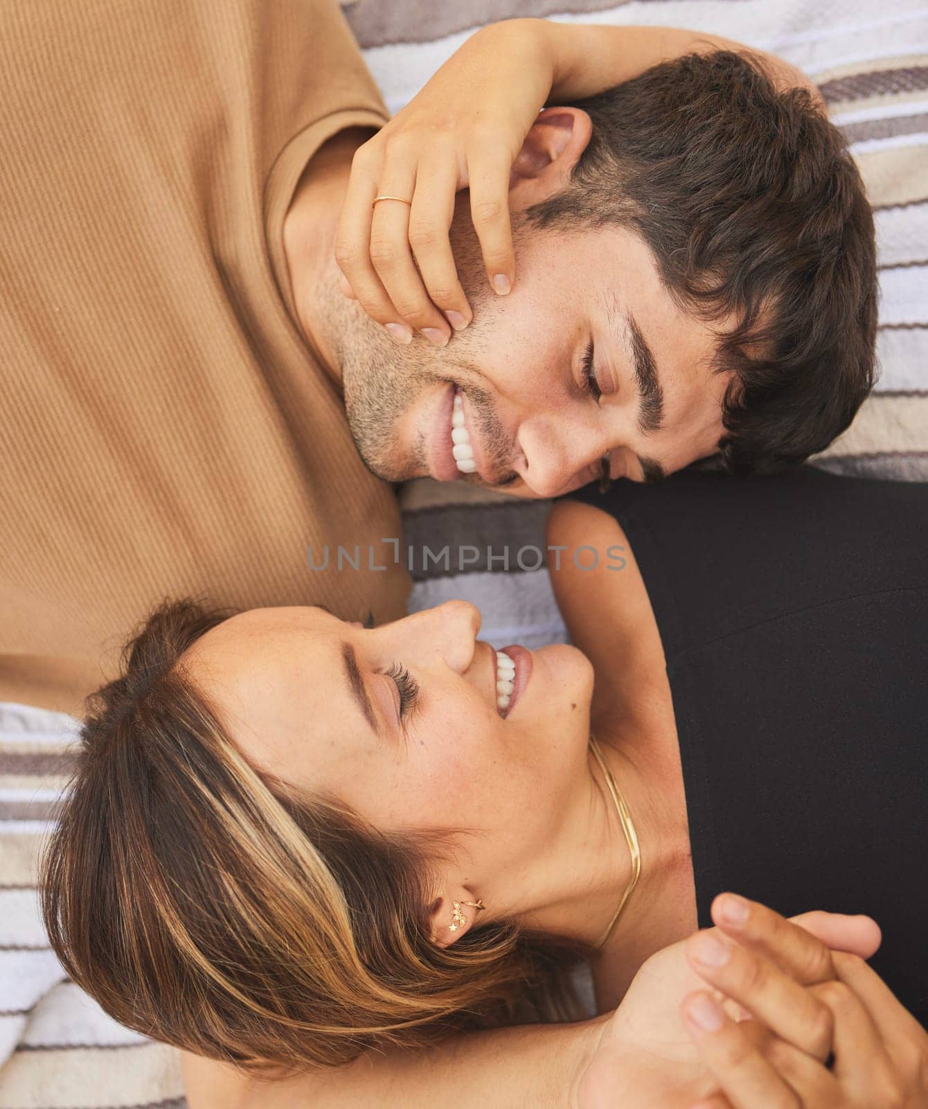 Top view, love and couple looking happy, smile and together for bonding, romance or relationship. Romantic, man and woman being loving, happiness or intimacy for affection, dating or content to relax.