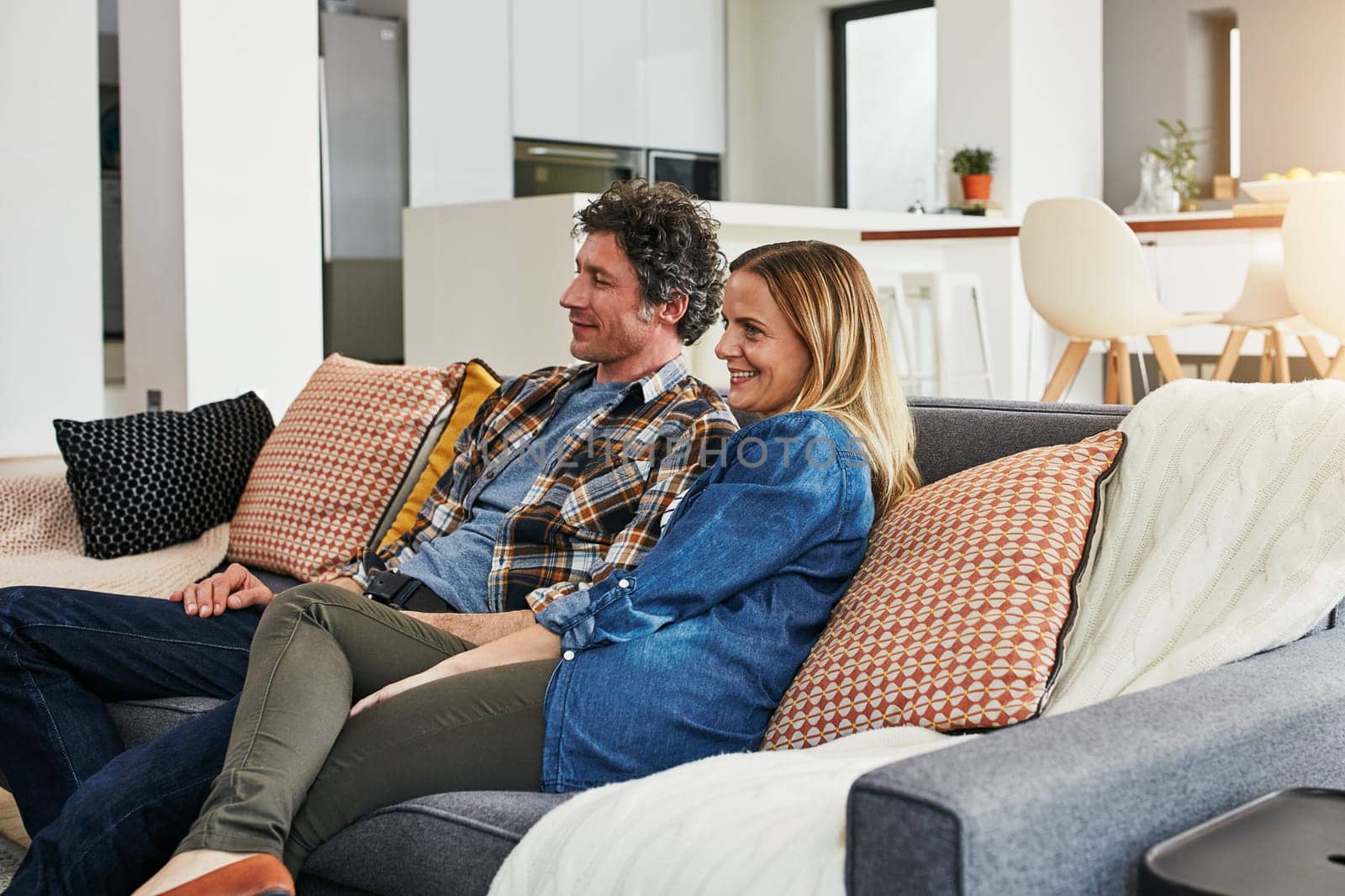 Happy couple, relax and watching tv in home for movie, film show and news broadcast in living room. Mature man, woman and smile on sofa for television series, video subscription or streaming platform.
